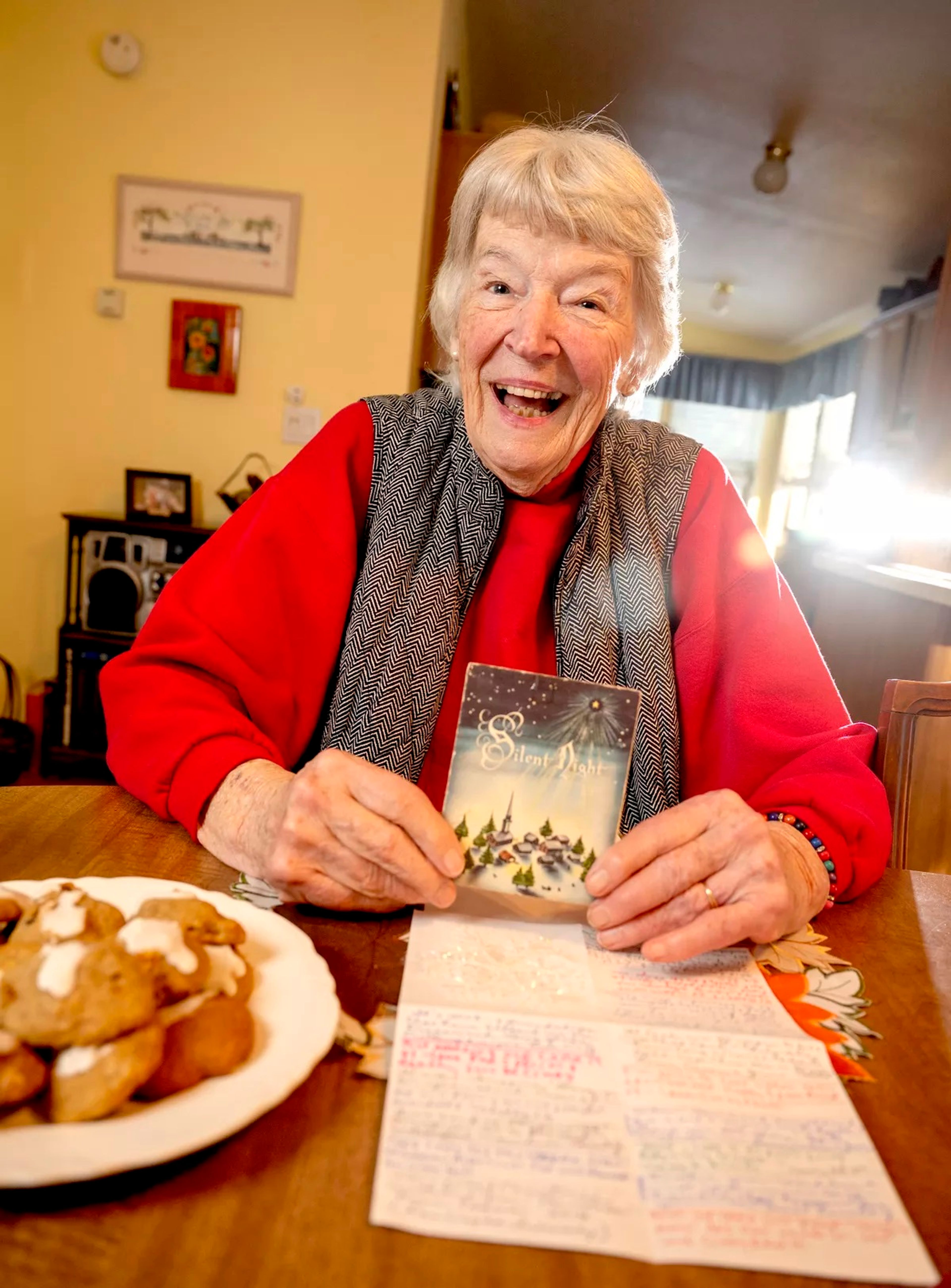 Cassie Hill, of Deer Park, holds the Christmas card she and a friend have been sending back and forth to each other for 65 years.