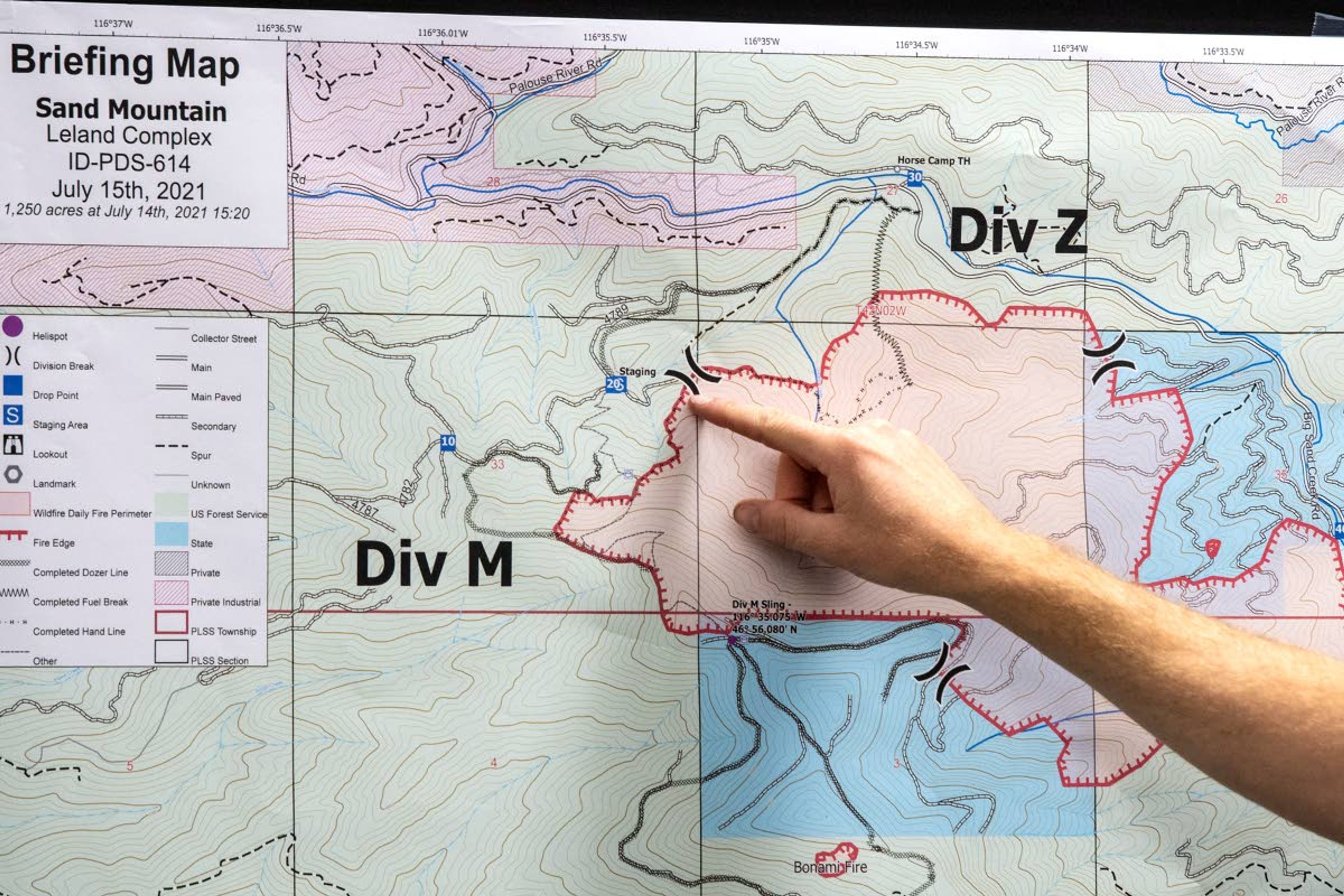 Incident Command Mike McManus, of the Type 3 North Idaho Incident Management team, points out a division break in the Sand Mountain Fire during a briefing with Idaho Gov. Brad Little at Deary High School on Thursday morning.