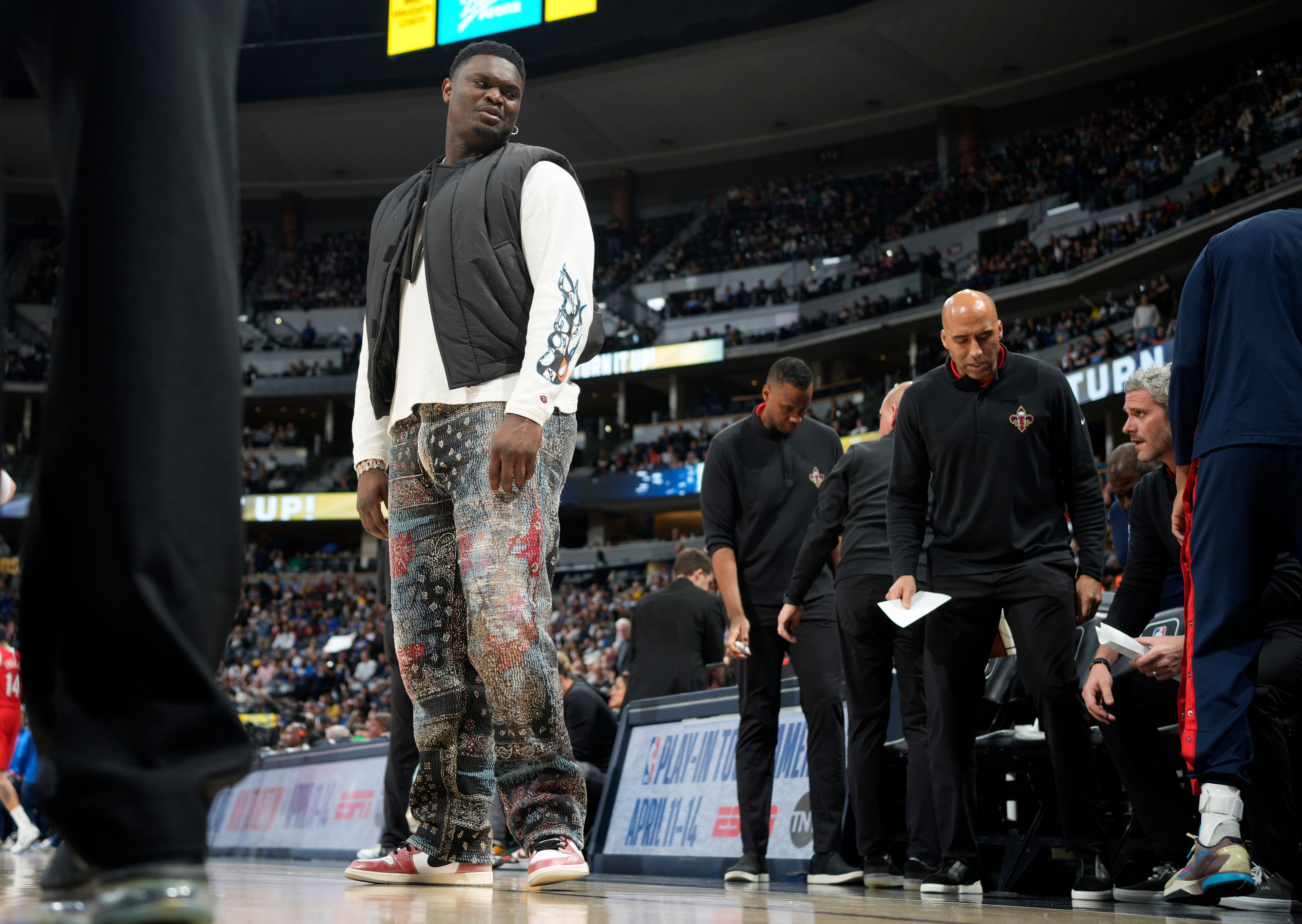 Injured New Orleans Pelicans forward Zion Williamson heads back to the bench after a timeout late in the second half of the team's NBA basketball game against the Denver Nuggets on Thursday, March 30, 2023, in Denver. (AP Photo/David Zalubowski)