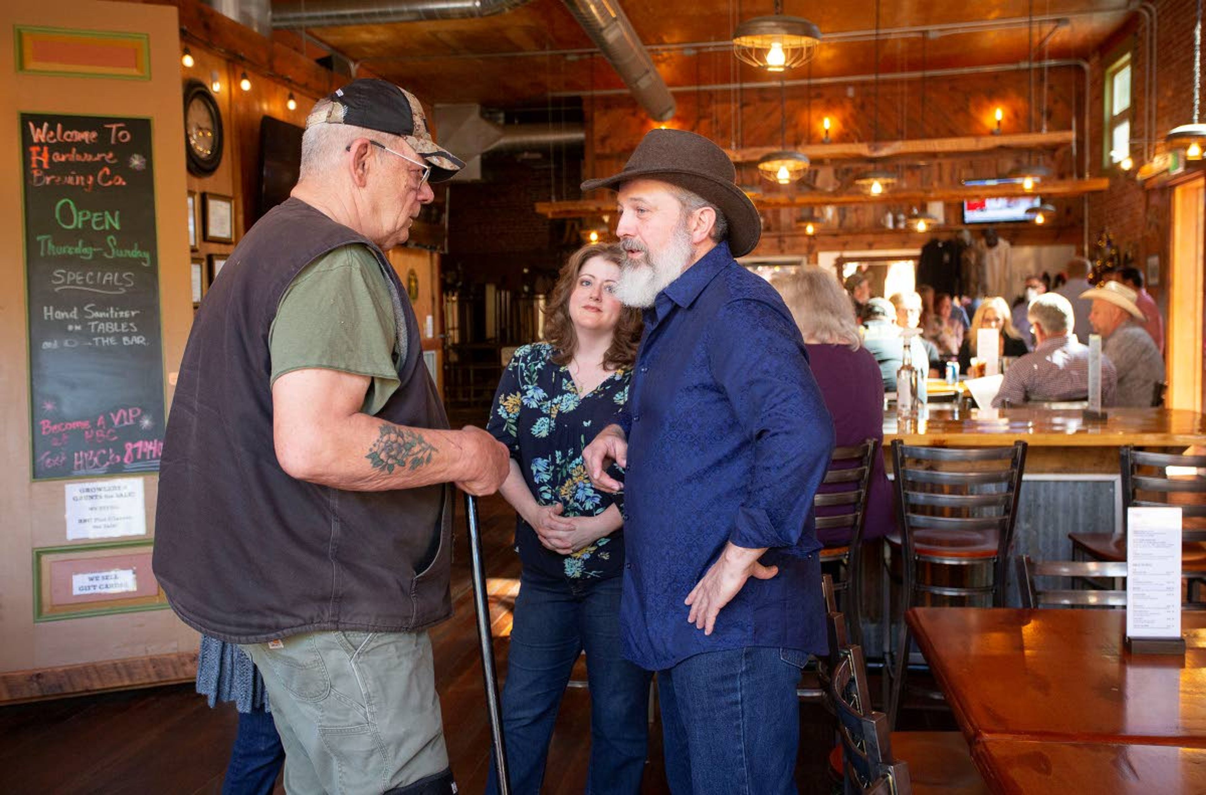 Customers talk on Friday at the Hardware Brewing Co. in Kendrick. The business reopened to sit-down customers on Friday even though Gov. Brad Little's order still restricts restaurants to curbside and delivery sales.