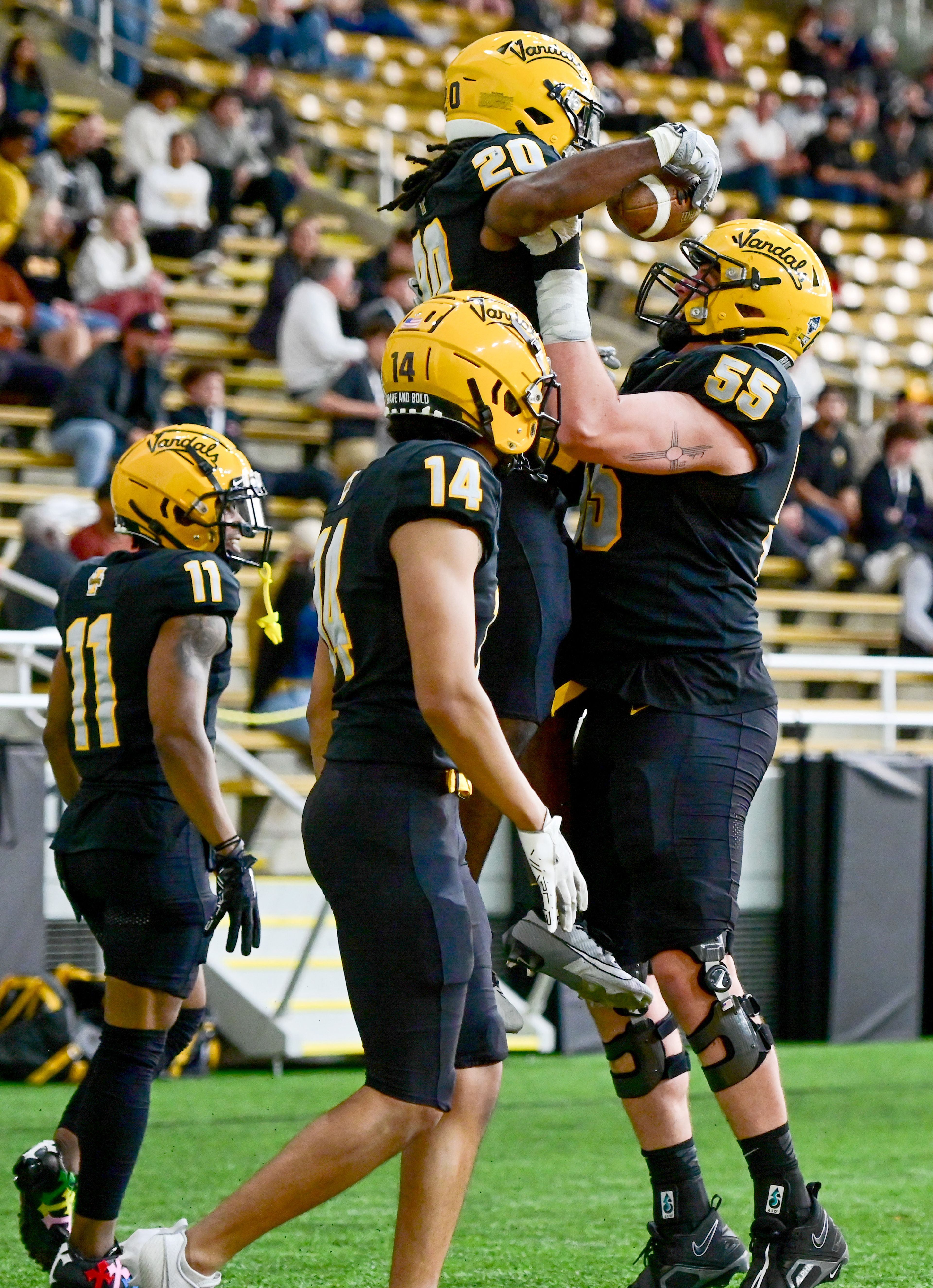 Vandals running back Elisha Cummings (20) is lifted in celebration of a touchdown at the annual spring game at the P1FCU Kibbie Dome in Moscow on Friday.