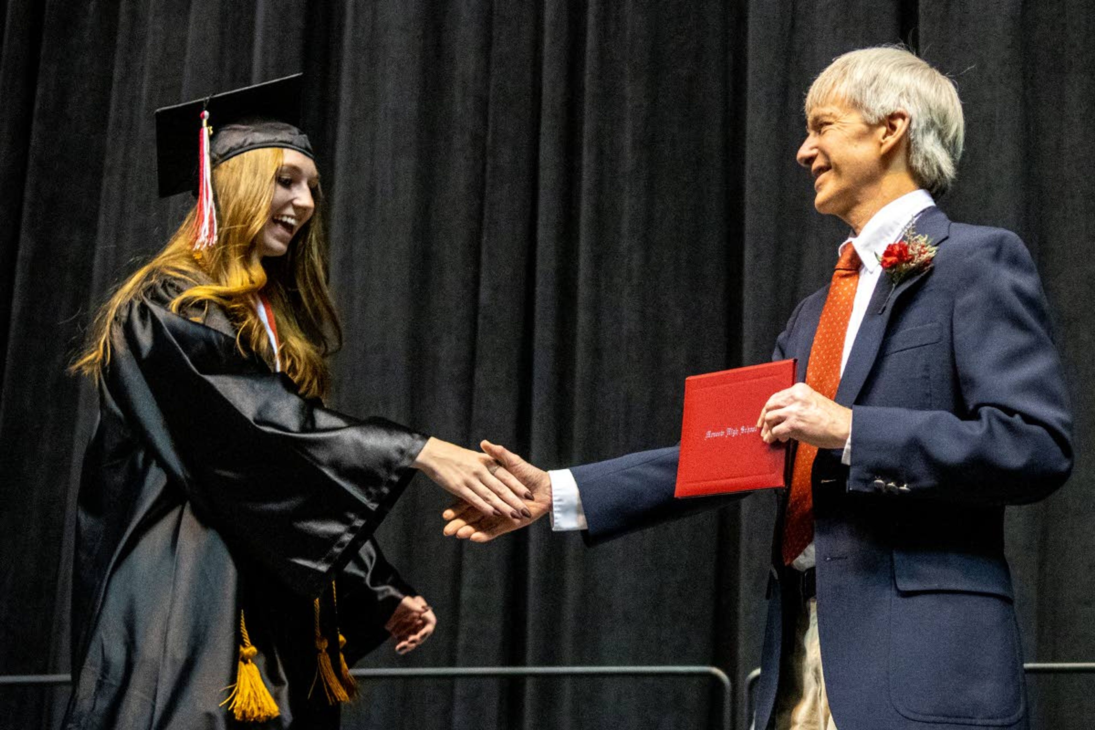 Graduate Shelby Davis receives her diploma from Moscow High School during the Class of 2021 graduation commencement at the University of Idaho’s Kibbie Dome on Friday night.