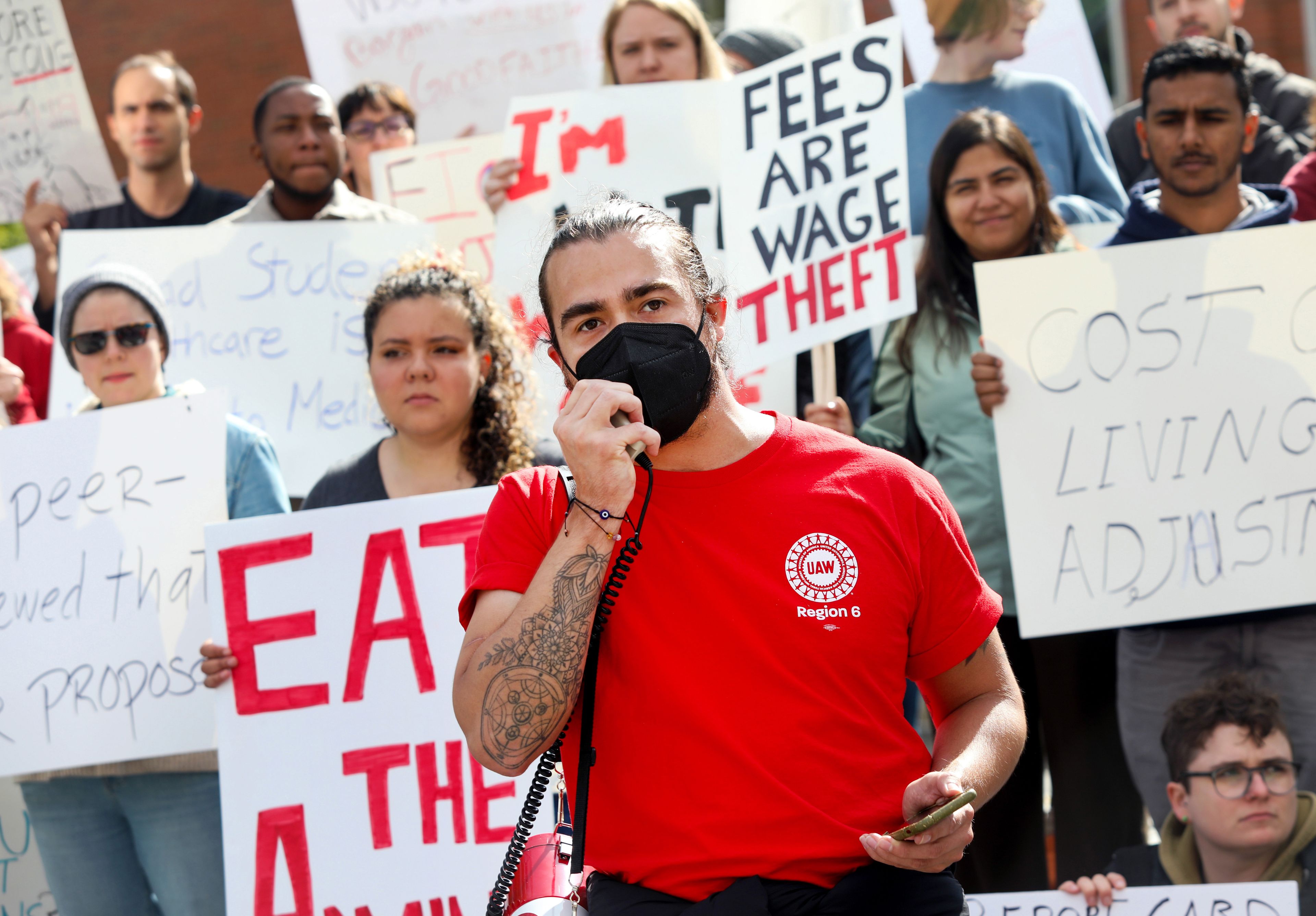 Gavin Doyle, center, a third-year PhD student in rhetoric and composition studies at Washington State University, speaks at a rally supporting contract negotiations for Academic Student Employees at Glenn Terrell Mall on Wednesday in Pullman.