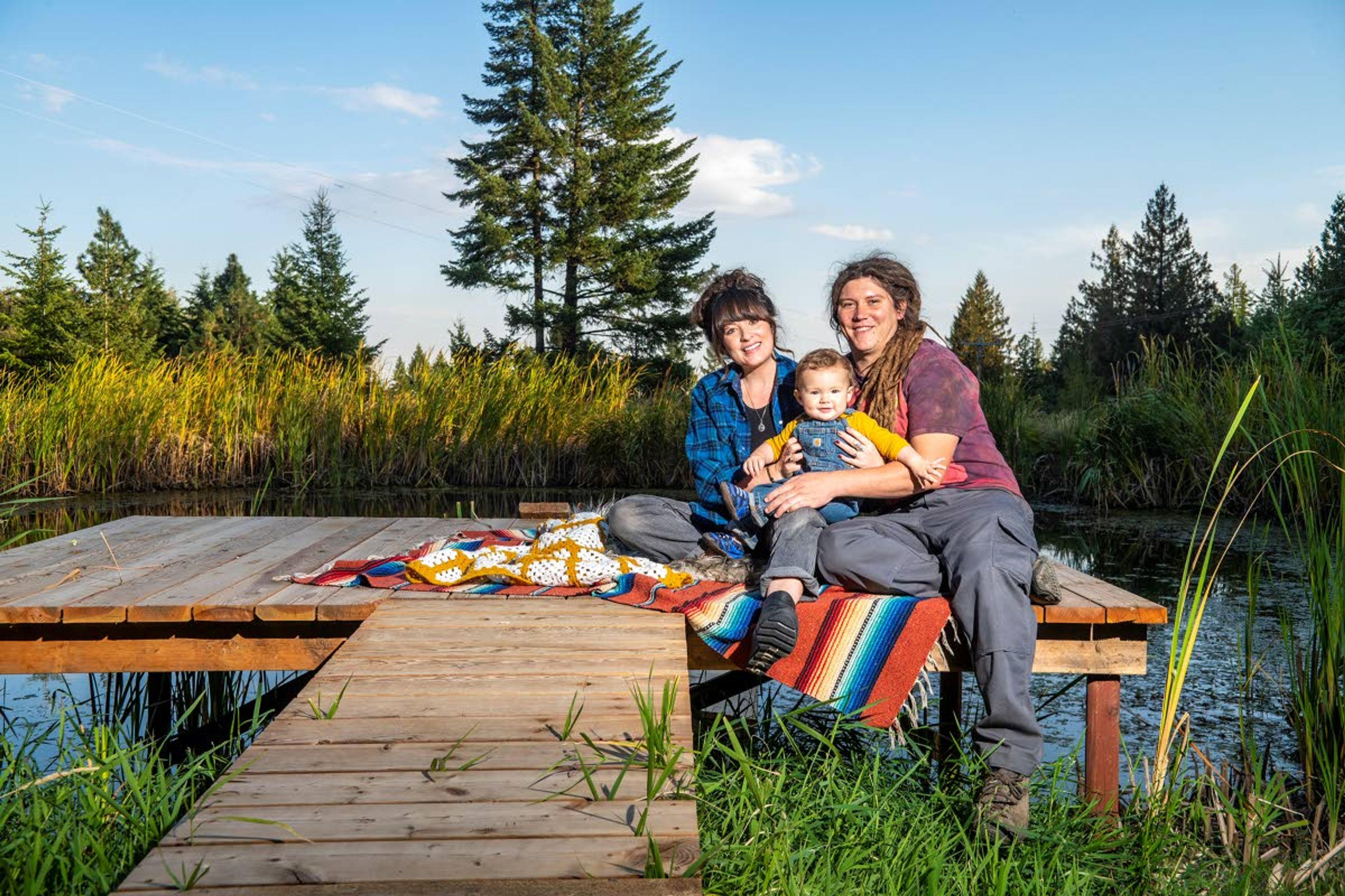 Jeanne, left, Danny and their 10-month-old son, Elton, will share the last name Happy once paperwork is finalized in November. The family is posing for a portrait on their pond-side dock Wednesday evening in Moscow. Changing their last nem to Happy "was just something that we did to become a family,” Jeanne said.