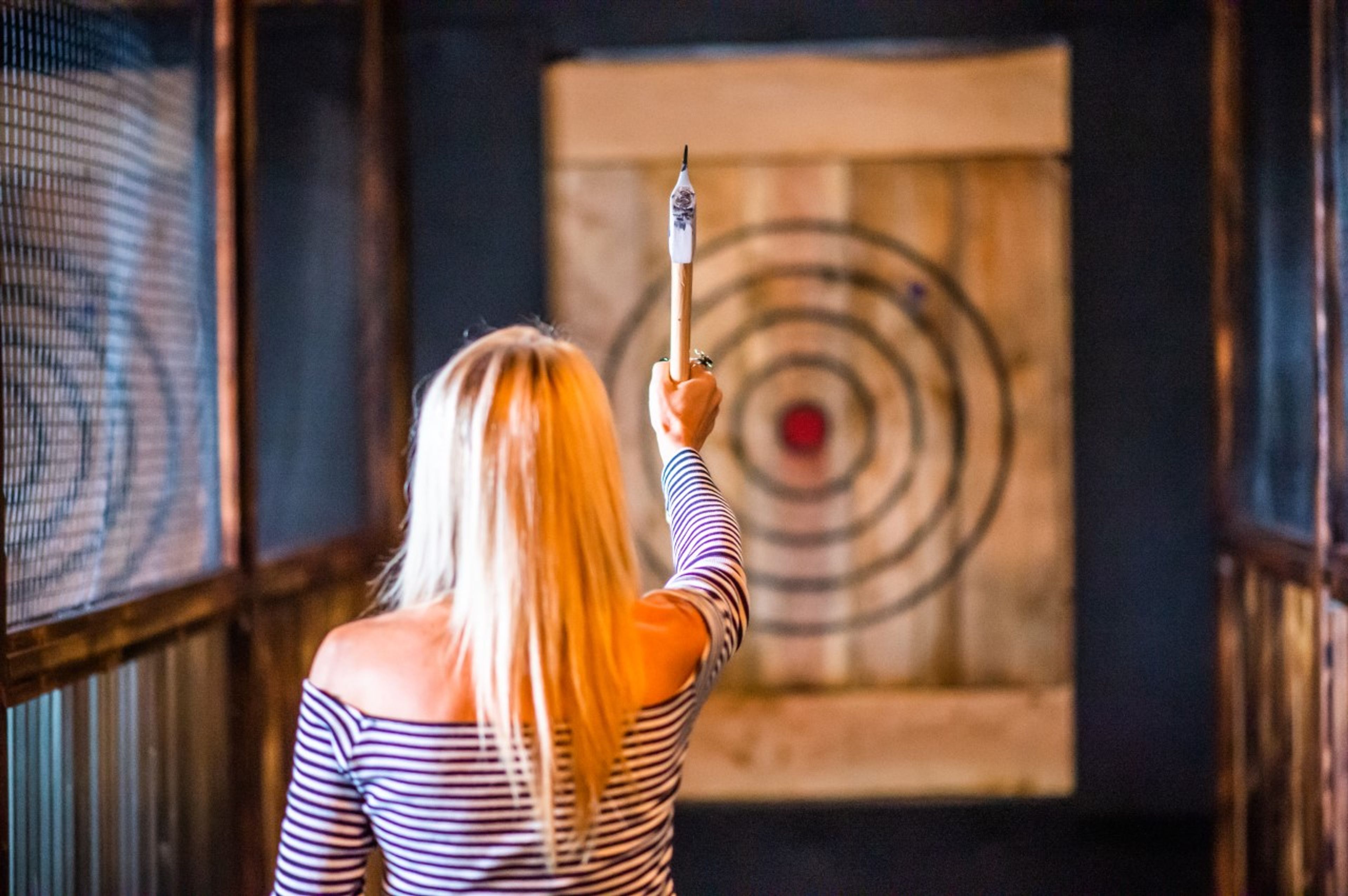 A customer readies to toss an ax at Moscow Axe Throwing. The business gives all customers instruction in basic technique and safety as part of their experience.