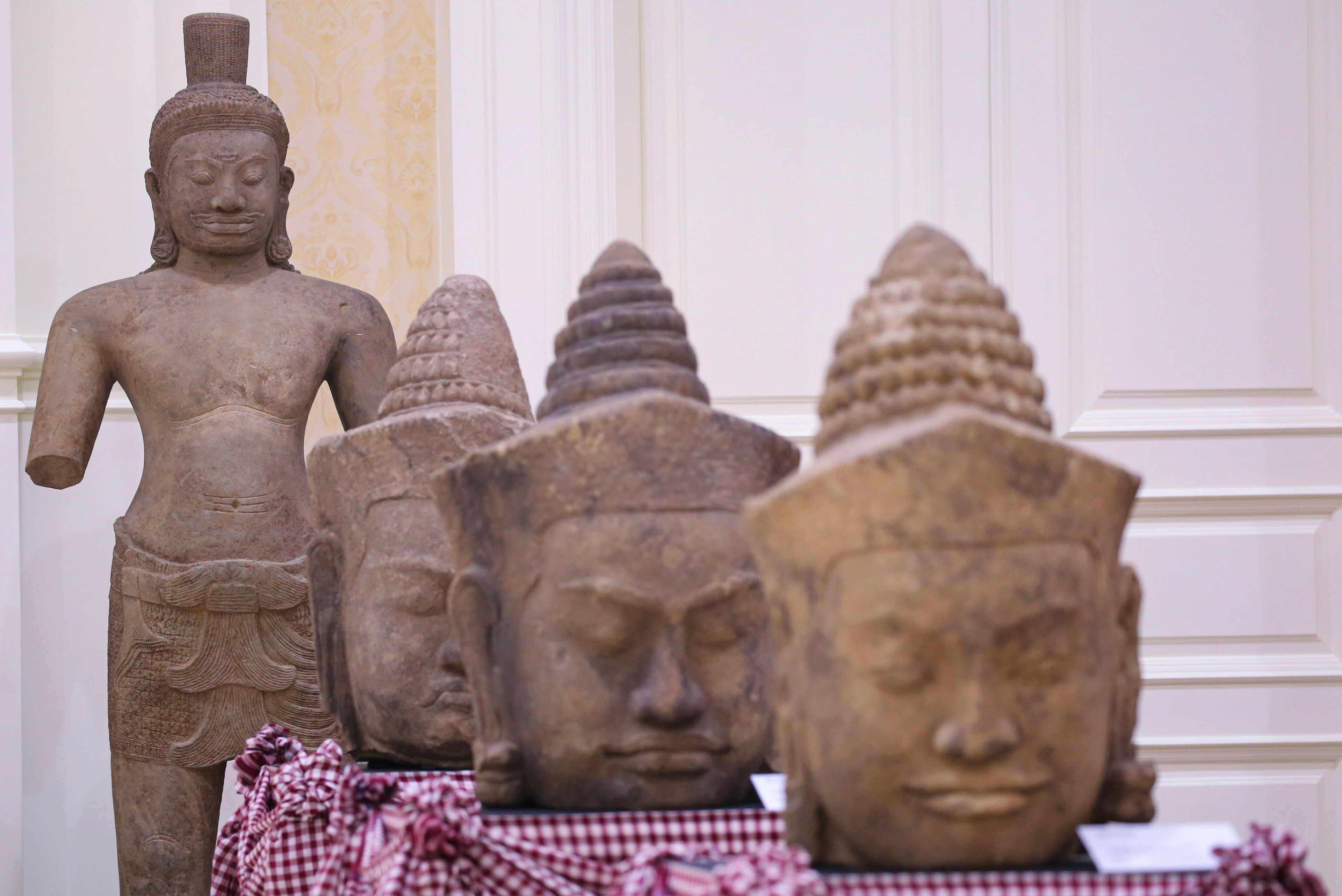 In this photo released by Agence Kampuchea Press (AKP), artifact statues are displayed during a ceremony for the return of artifacts at Peace Palace in Phnom Penh, Cambodia, Thursday, Aug. 22, 2024. (AKP via AP)