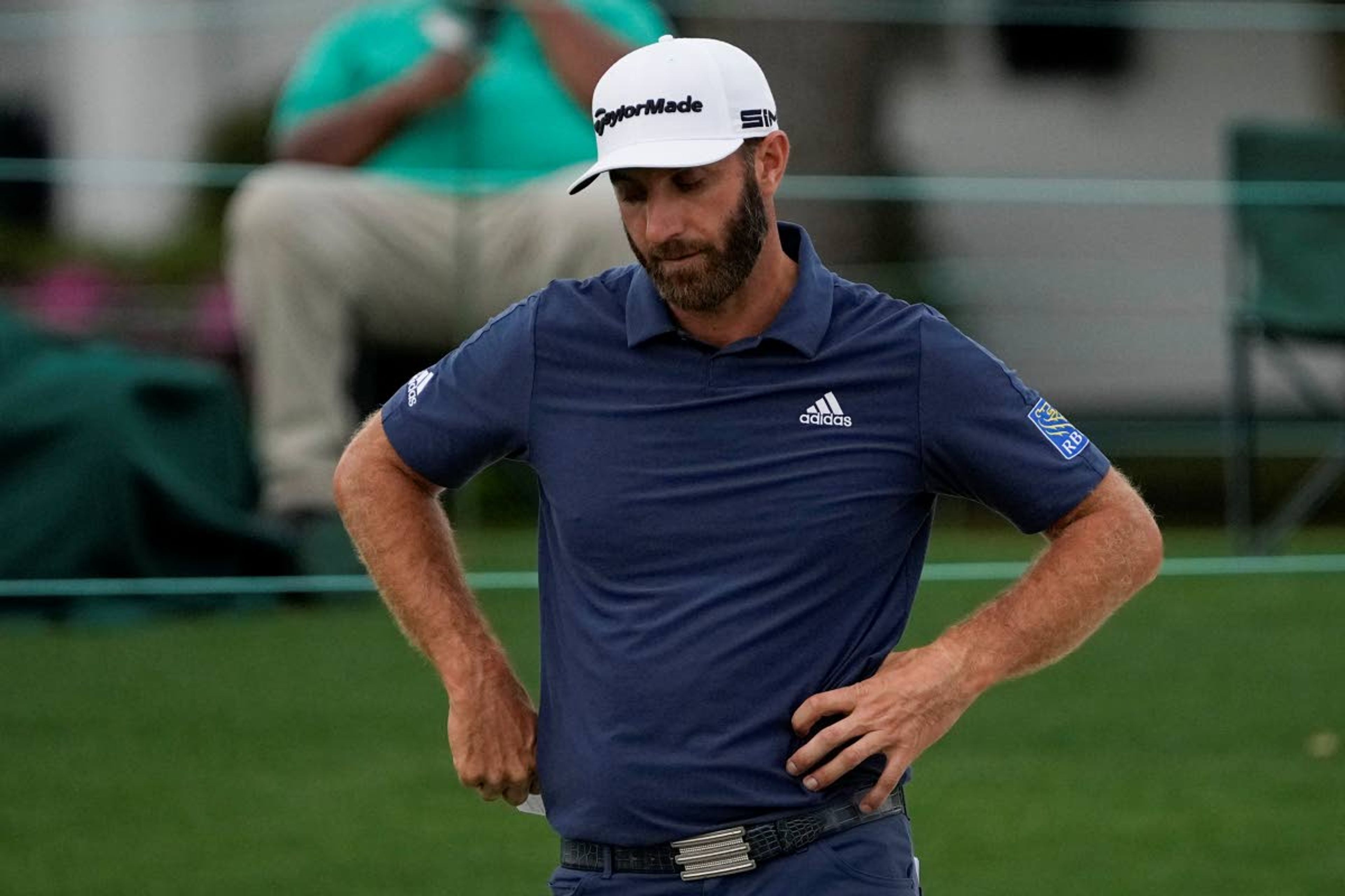 Dustin Johnson looks down after putting on the 18th hole during the second round of the Masters golf tournament on Friday, April 9, 2021, in Augusta, Ga. (AP Photo/Gregory Bull)