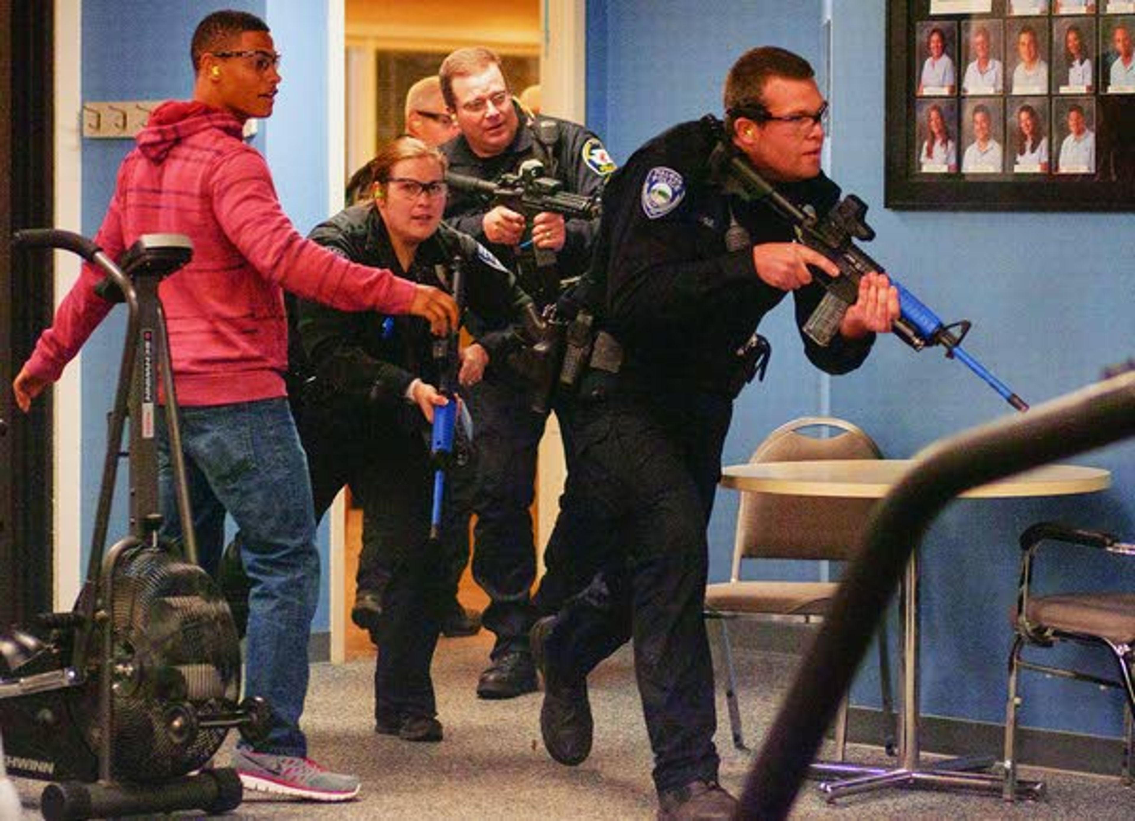 Police officers (front to back) Chris Engle, Heidi Lambly, Monty Griffin and Jeff Olmstead enter a room where they suspect an "active shooter" is during a response drill run by the Pullman Police Department on Sunday at Summit Therapy in Pullman. Griffin and Olmstead are officers with the Washington State University Police Department.