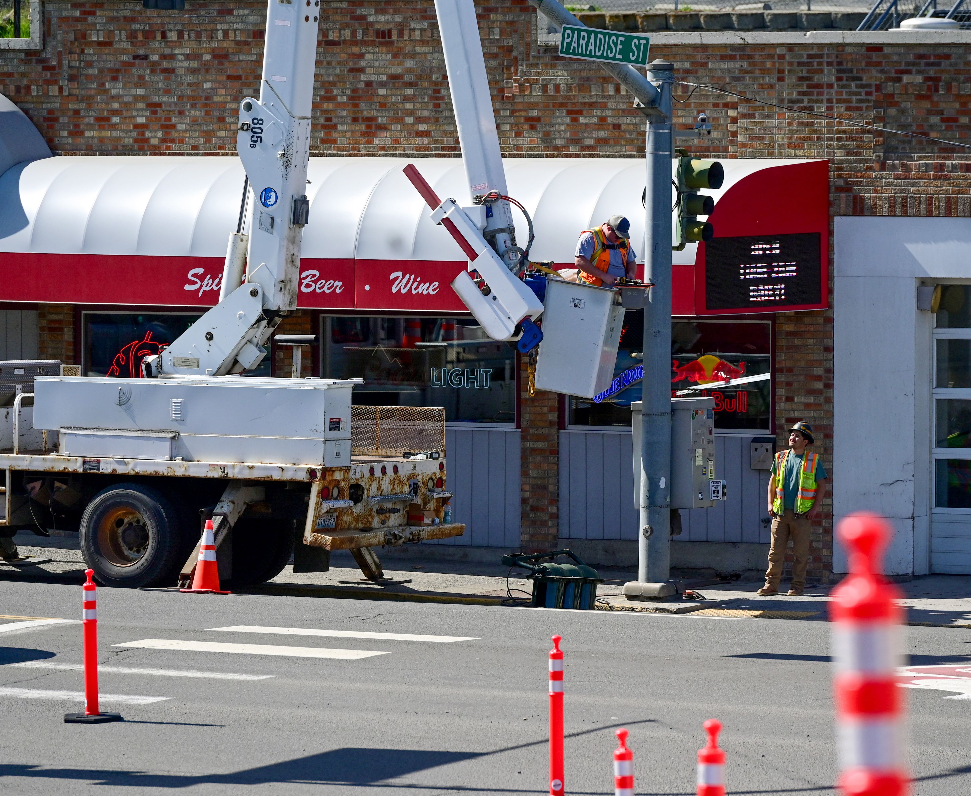 Work is done on a traffic light at the intersection of Paradise Street and Grand Avenue in Pullman on Monday before the start of construction on Main Street.