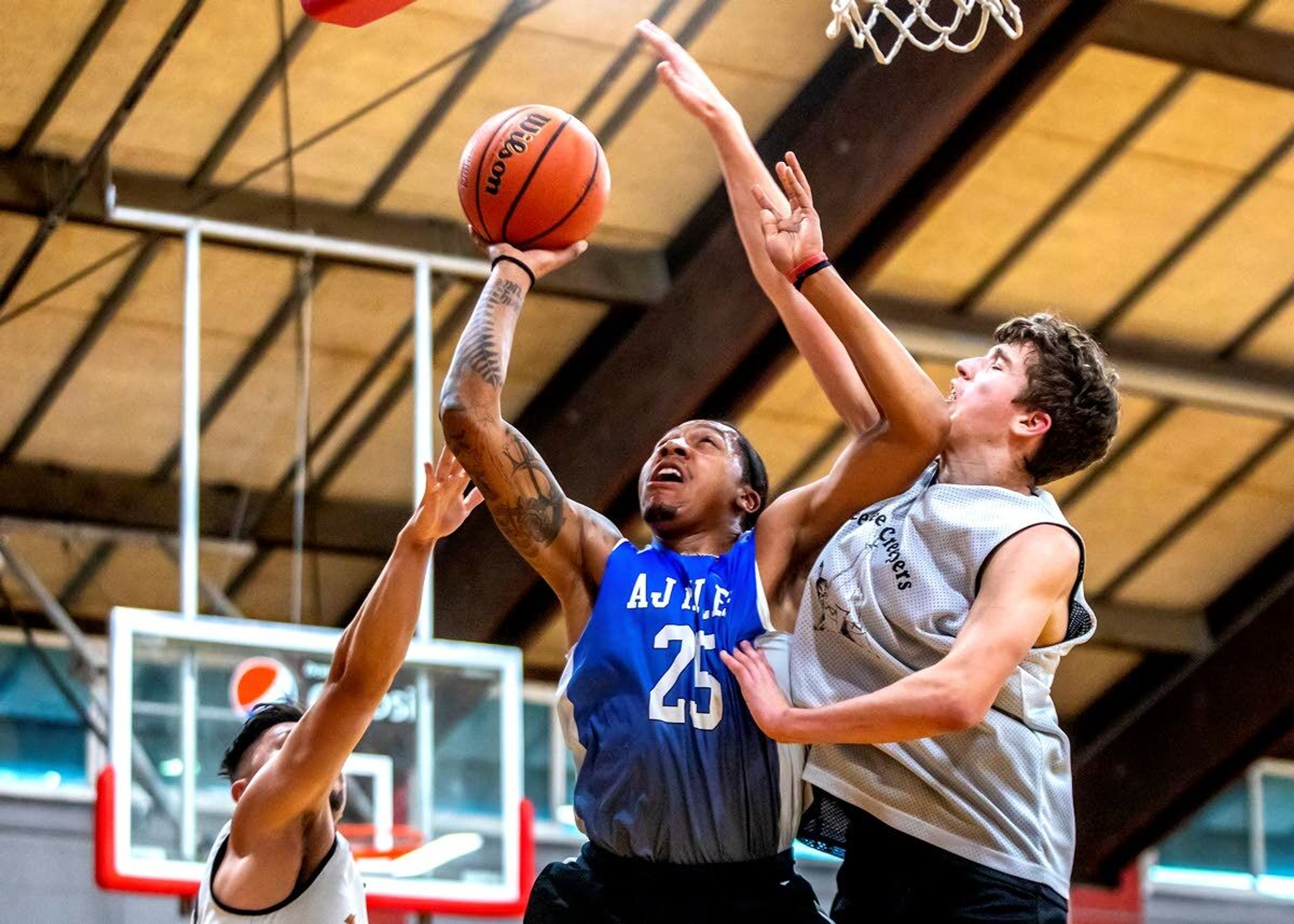 Former Clarkston and University of Idaho standout Trevon Allen, center, puts up a shot playing for Team AJ during the AJ Miles Memorial basketball tournament Saturday at the Pi-Nee-Waus Community Center in Lapwai.