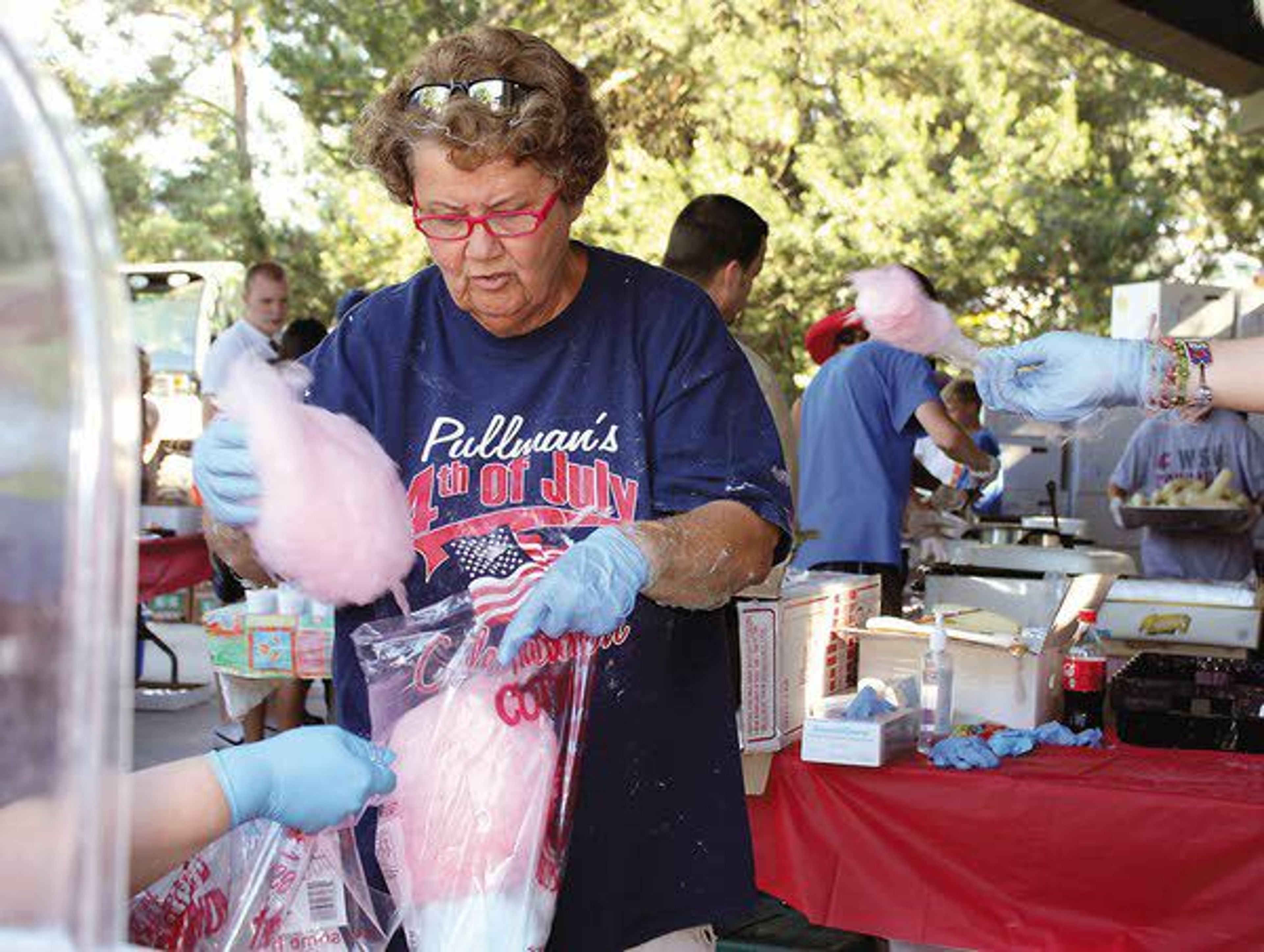 Sue Hinz prepares cotton candy during Pullman’s Independence Day celebration in 2013. Hinz has prepared cotton candy at the event for more than 25 years.