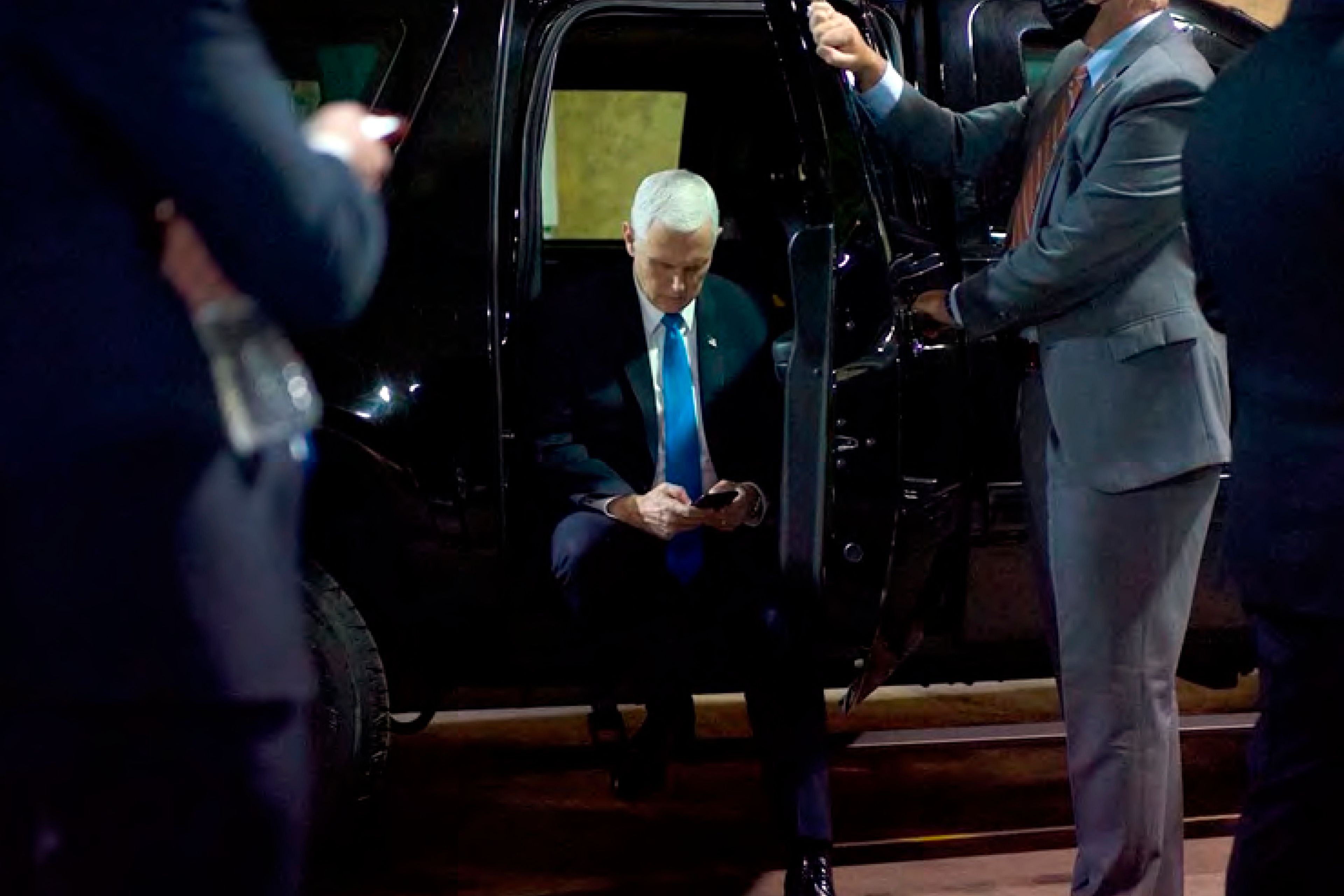 In this image released in the final report by the House select committee investigating the Jan. 6 attack on the U.S. Capitol, on Thursday, Dec. 22, 2022, Vice President Mike Pence looks at a mobile device from a secured loading dock at the U.S. Capitol on Jan. 6, 2021. (House Select Committee via AP)