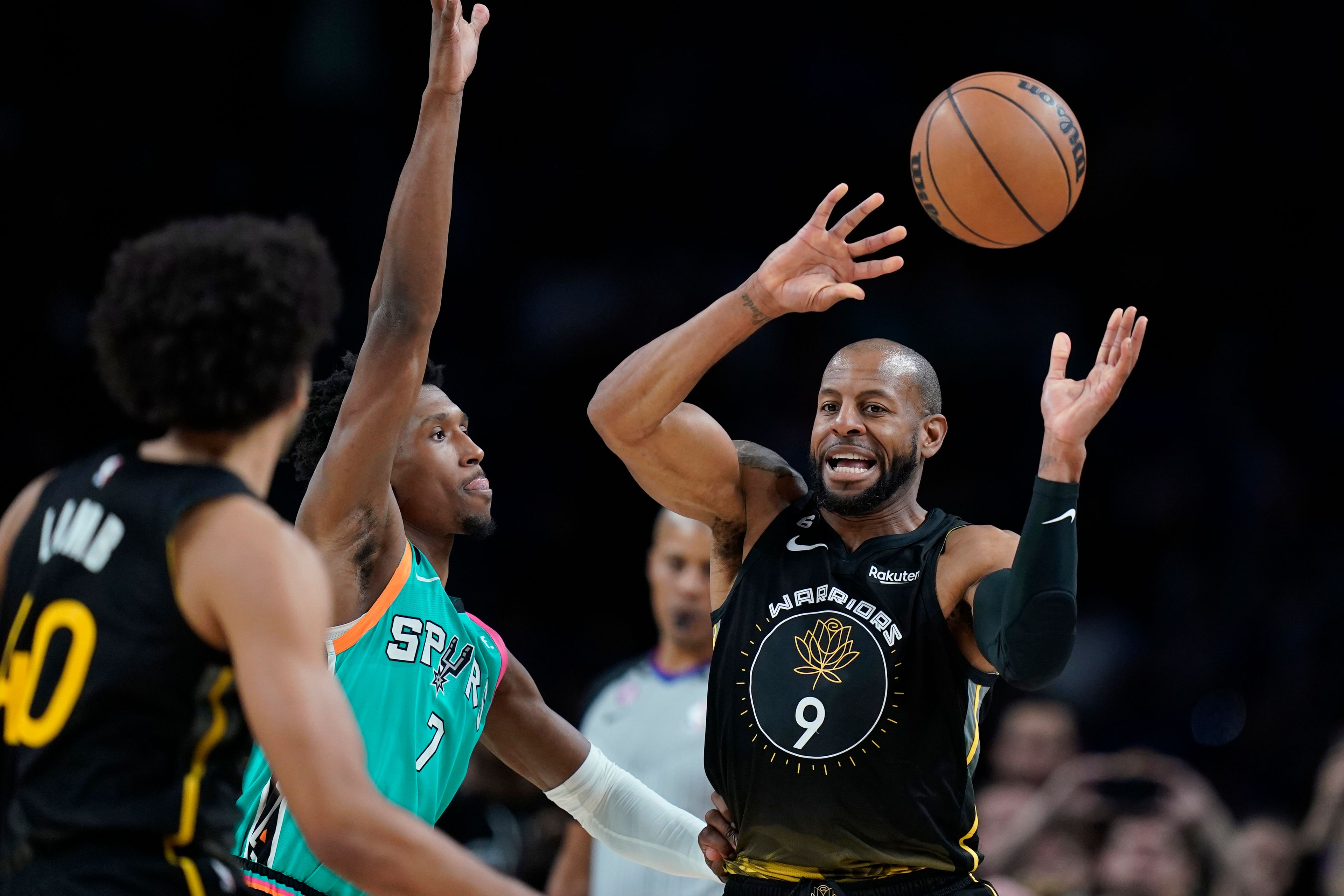 Golden State Warriors forward Andre Iguodala (9) moves the ball past San Antonio Spurs guard Josh Richardson (7) during the second half of an NBA basketball game in San Antonio, Friday, Jan. 13, 2023. (AP Photo/Eric Gay)