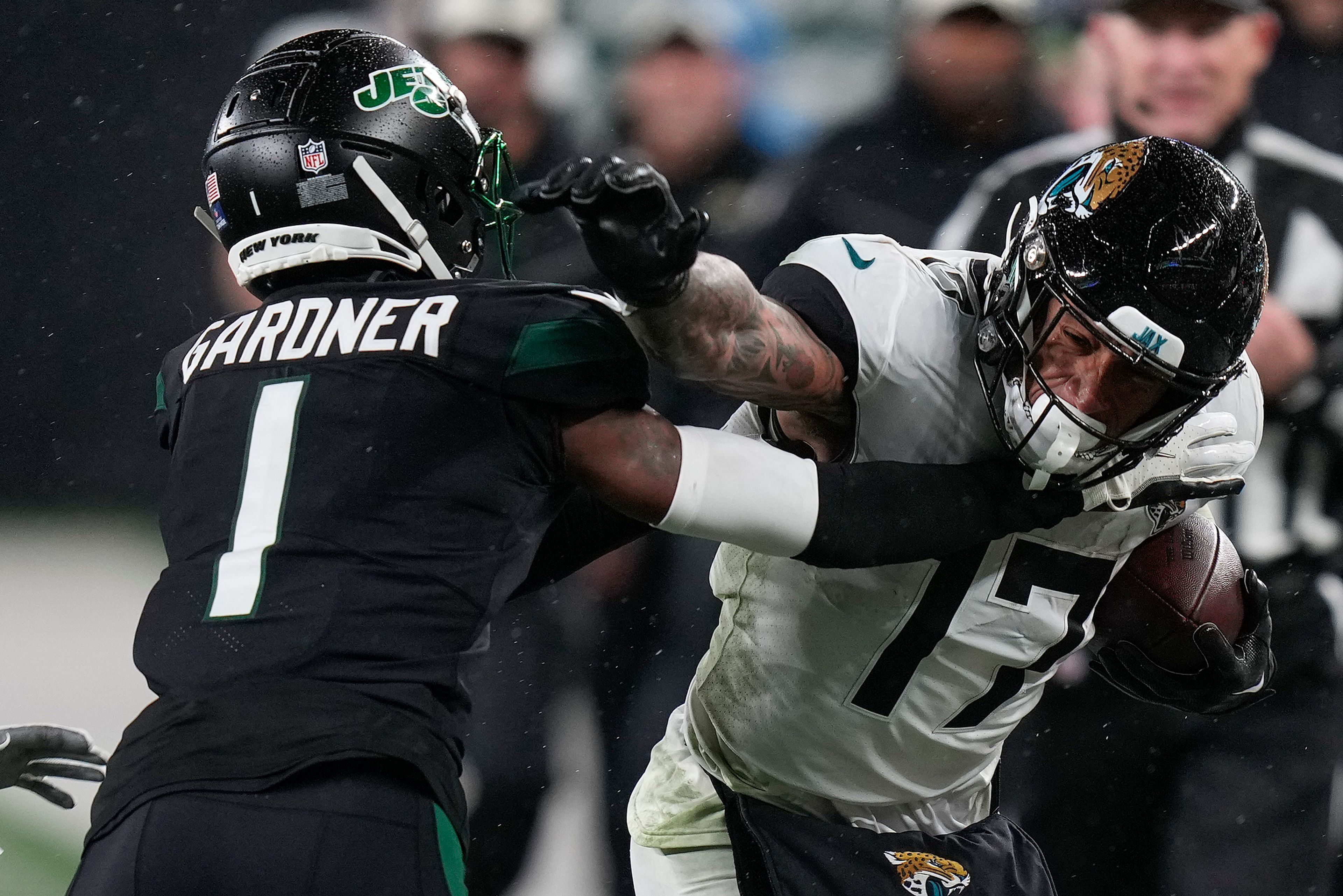 Jacksonville Jaguars tight end Evan Engram (17) stiff-arms New York Jets cornerback Sauce Gardner (1) during the third quarter of an NFL football game, Thursday, Dec. 22, 2022, in East Rutherford, N.J. (AP Photo/Seth Wenig)