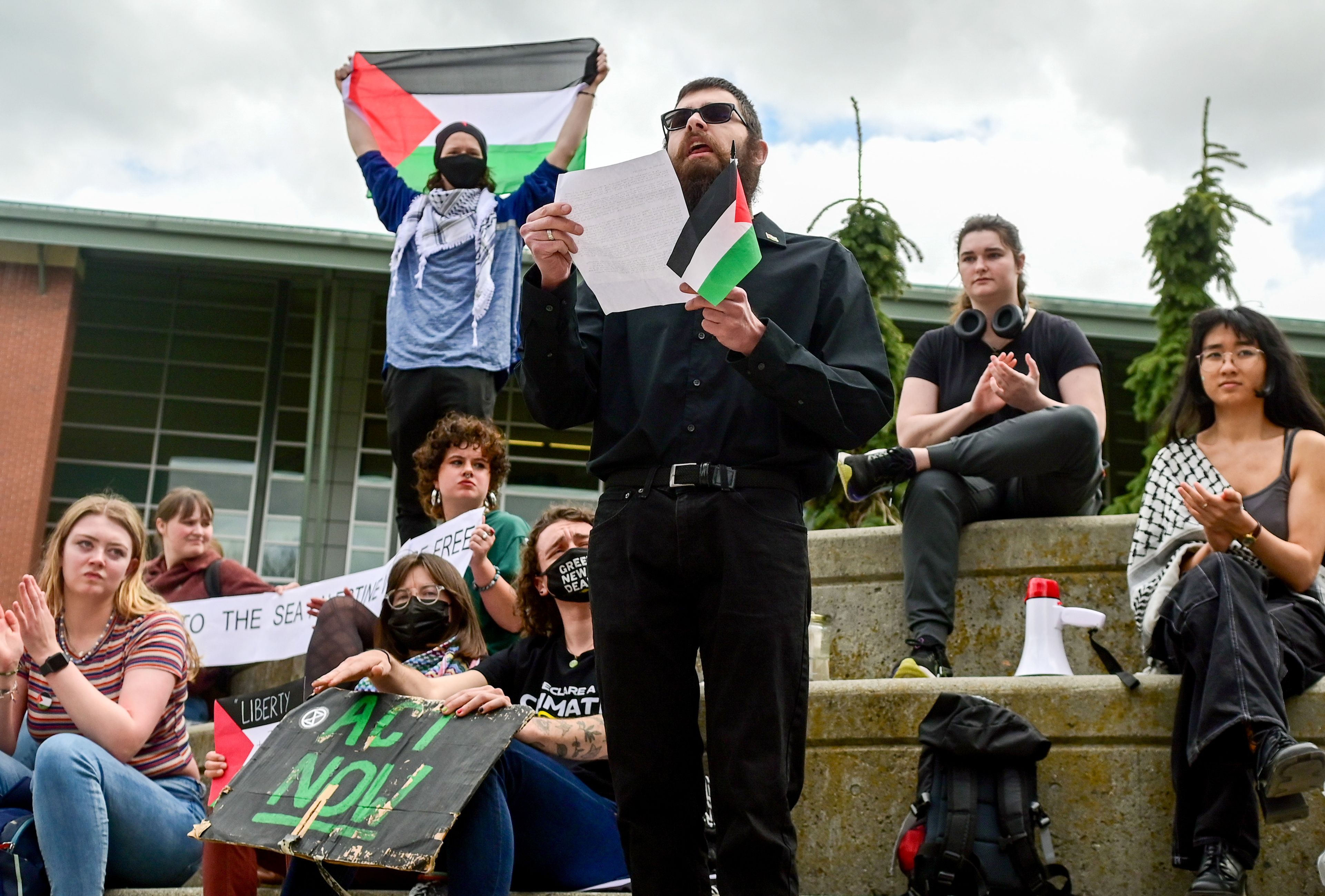 Sam Gironde, center, a University of Idaho alumnus and long-term Moscow resident, shares an address with those gathered at a Palestine Week of Action demonstration outside of the UI Library in Moscow.