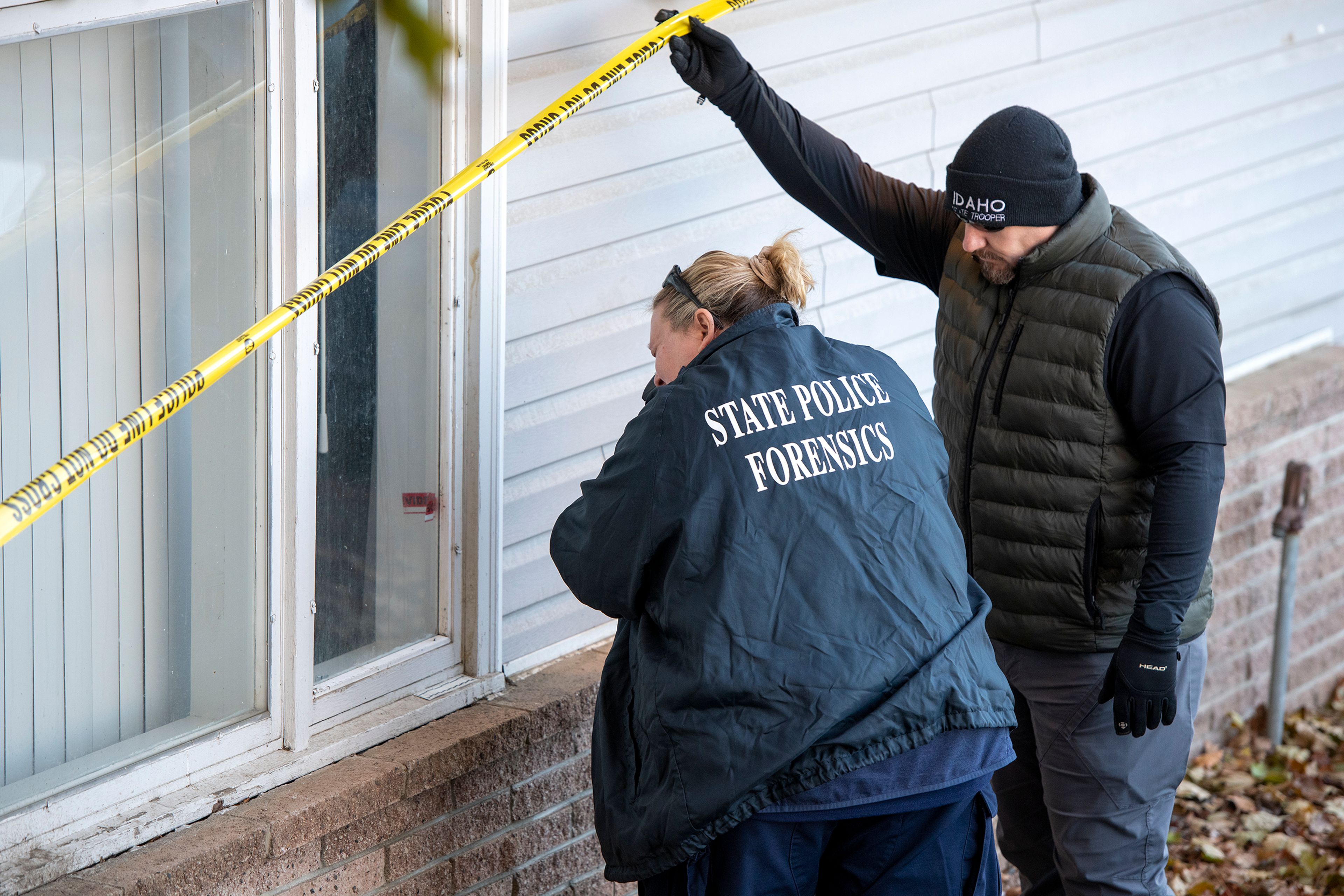 Members of the Idaho State Police forensic team investigate Friday at a home where four University of Idaho students were found murdered last weekend in Moscow.