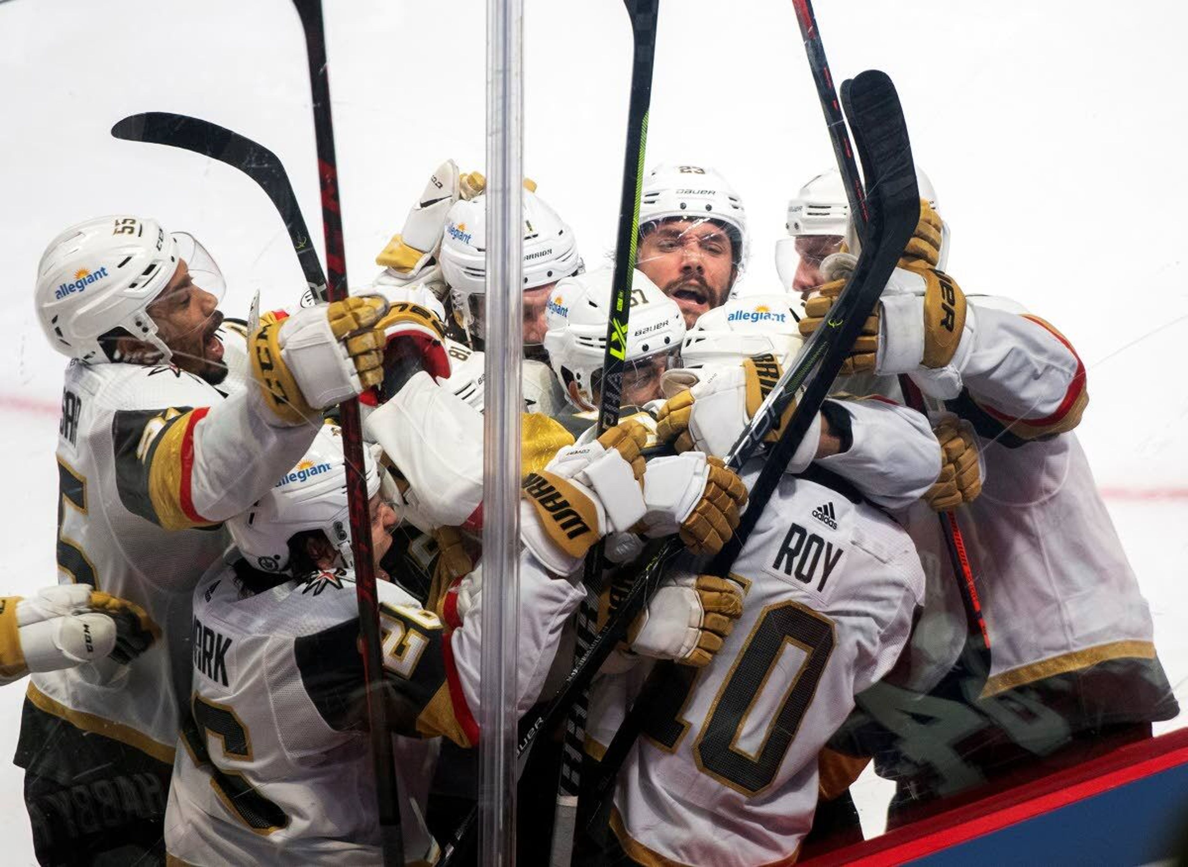 Vegas Golden Knights' Nicolas Roy (10) celebrates his game-winning goal against the Montreal Canadiens with teammates in overtime of Game 4 in an NHL Stanley Cup playoff hockey semifinal in Montreal, Sunday, June 20, 2021.