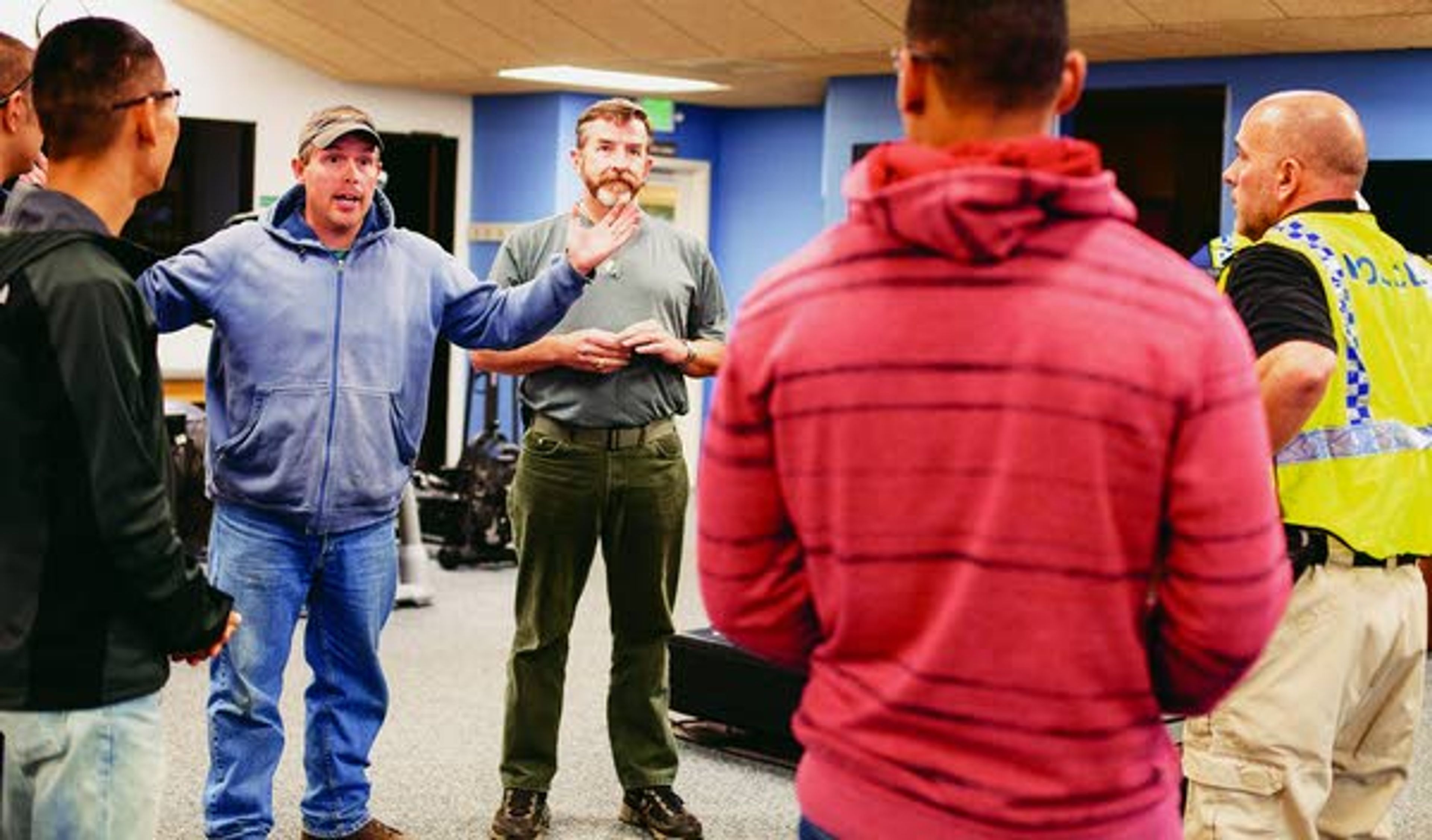 Pullman Police Department officer Aaron Breshears, second from left, who will play 'the shooter' explains scenario details to observers and participants in the Summit Therapy exercise area before an active shooter response drill run by the PPD on Sunday at Summit Therapy in Pullman.