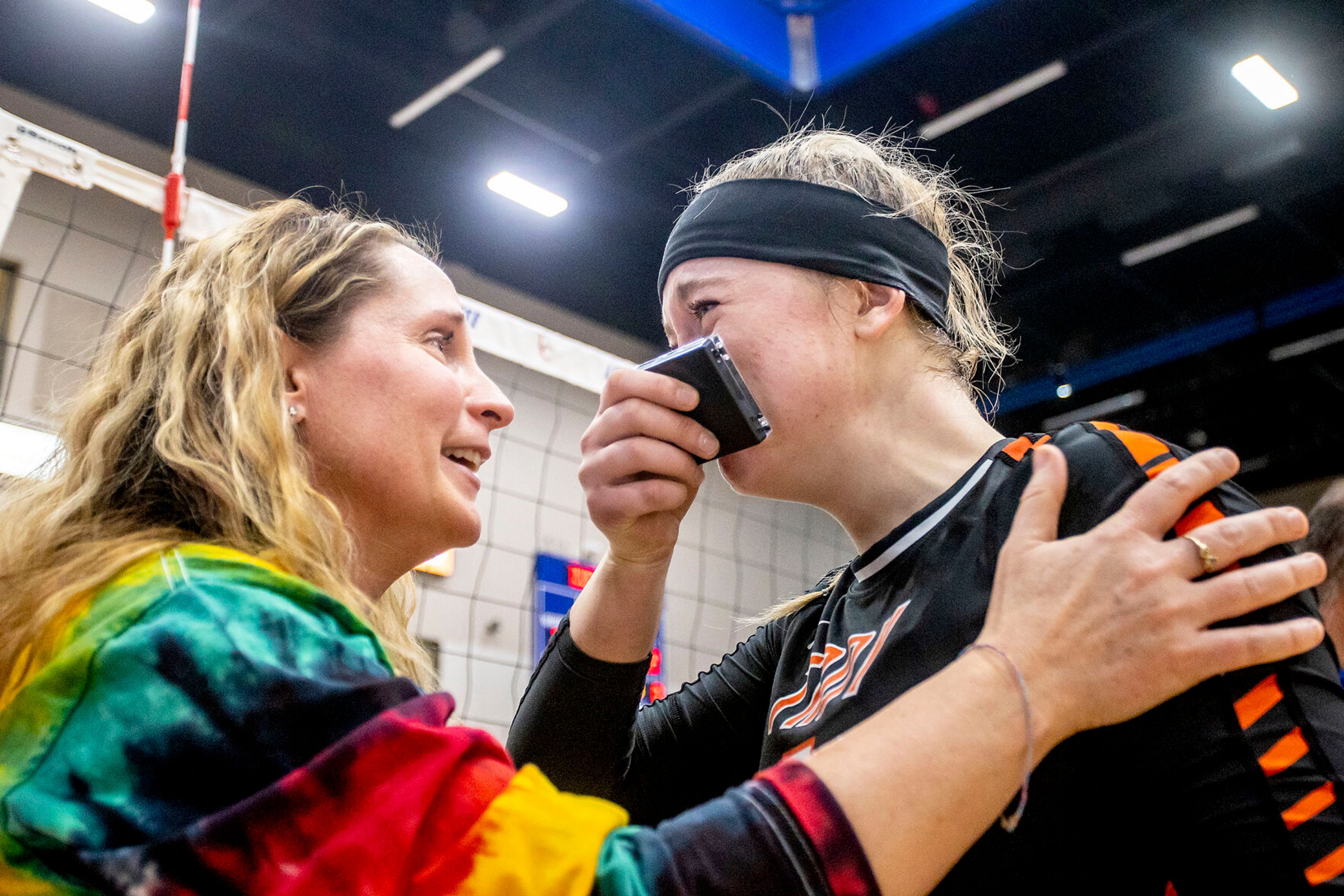 Morgan Blizzard cries as she is congratulated by Troy head coach Deborah Blazzard at the Lewis-Clark State College Athletic Center on Saturday. Troy defeated Grace in three sets to become the 1A DI state champions.