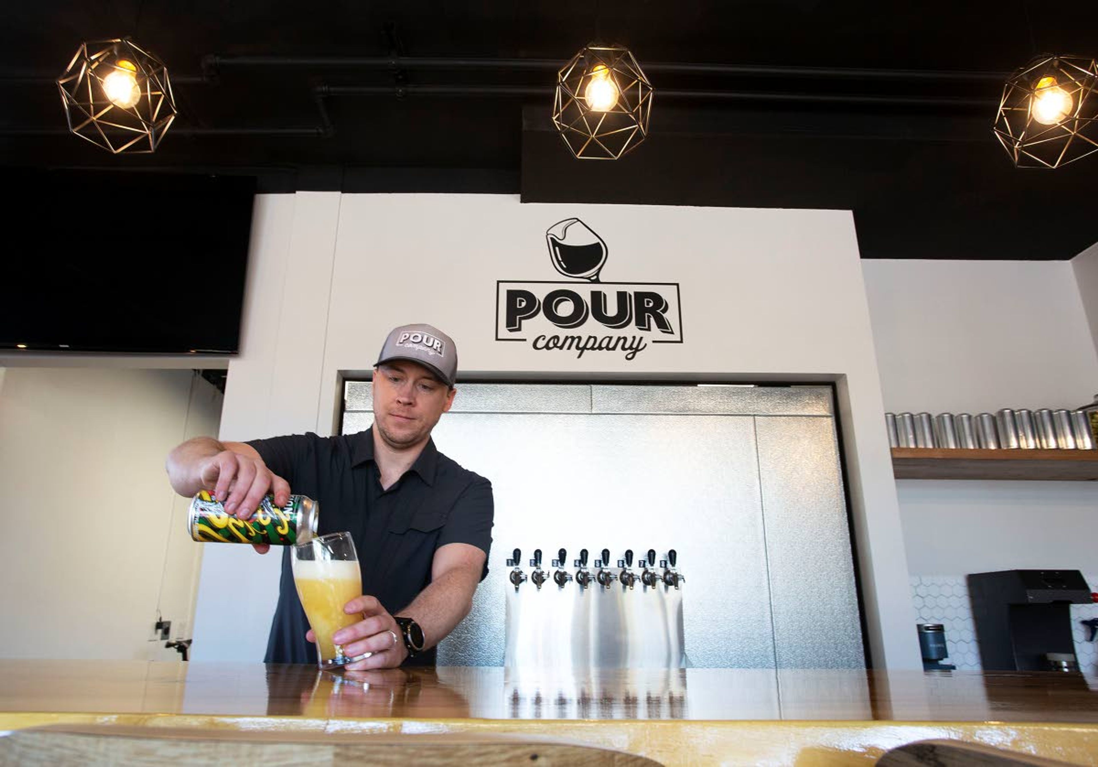 Owner Stefan Yauchzee pours a class of Revision Hazy Life IPA on at Pour Company in Moscow in this January 2022 file photo.