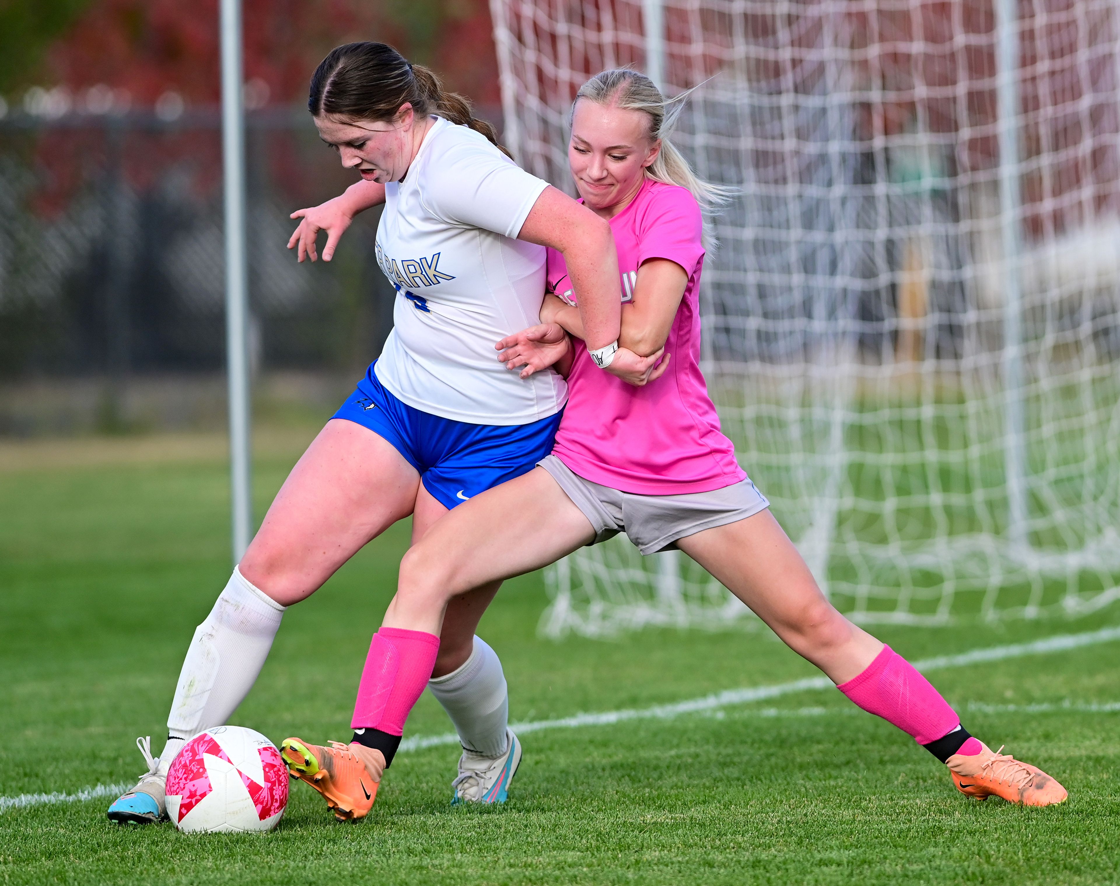 Pullman senior Emma Bobo fights to maintain control of the ball against Deer Park senior Kaylee Reiter Thursday in Pullman.,