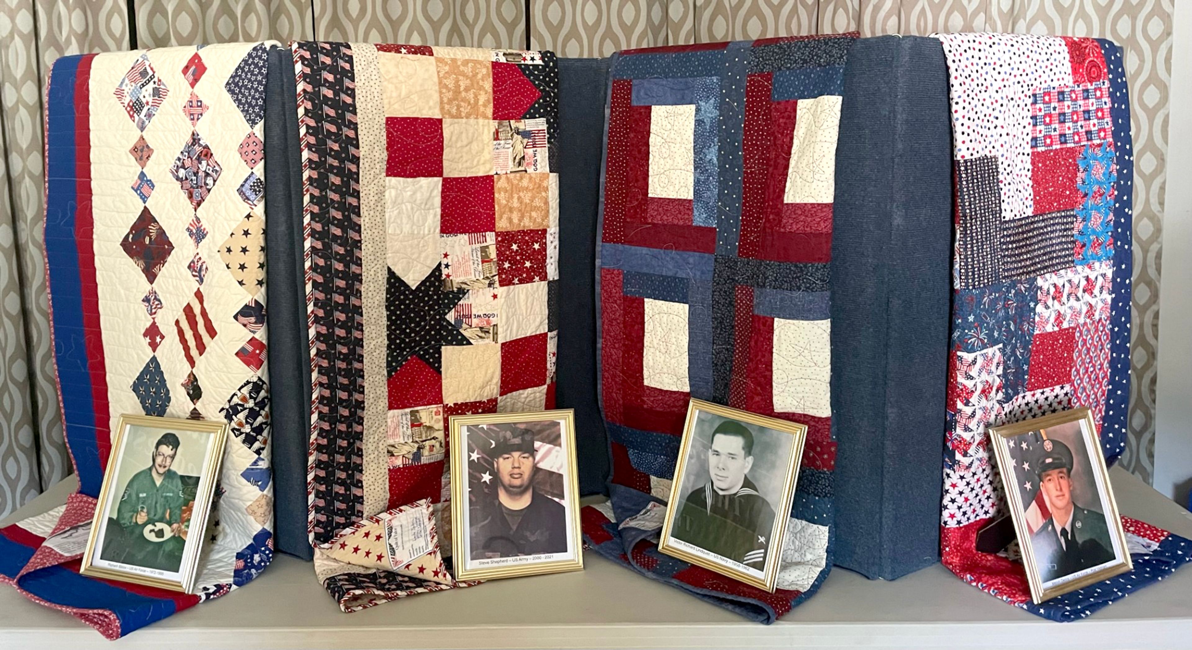 Quilts of valor that will be presented to Richard Silcox, from left, Air Force; Steven Shepherd, Army; Victor Lindquist, Navy; Melvin Denny, Air Force; sit on a table at the Troy Historical Society.