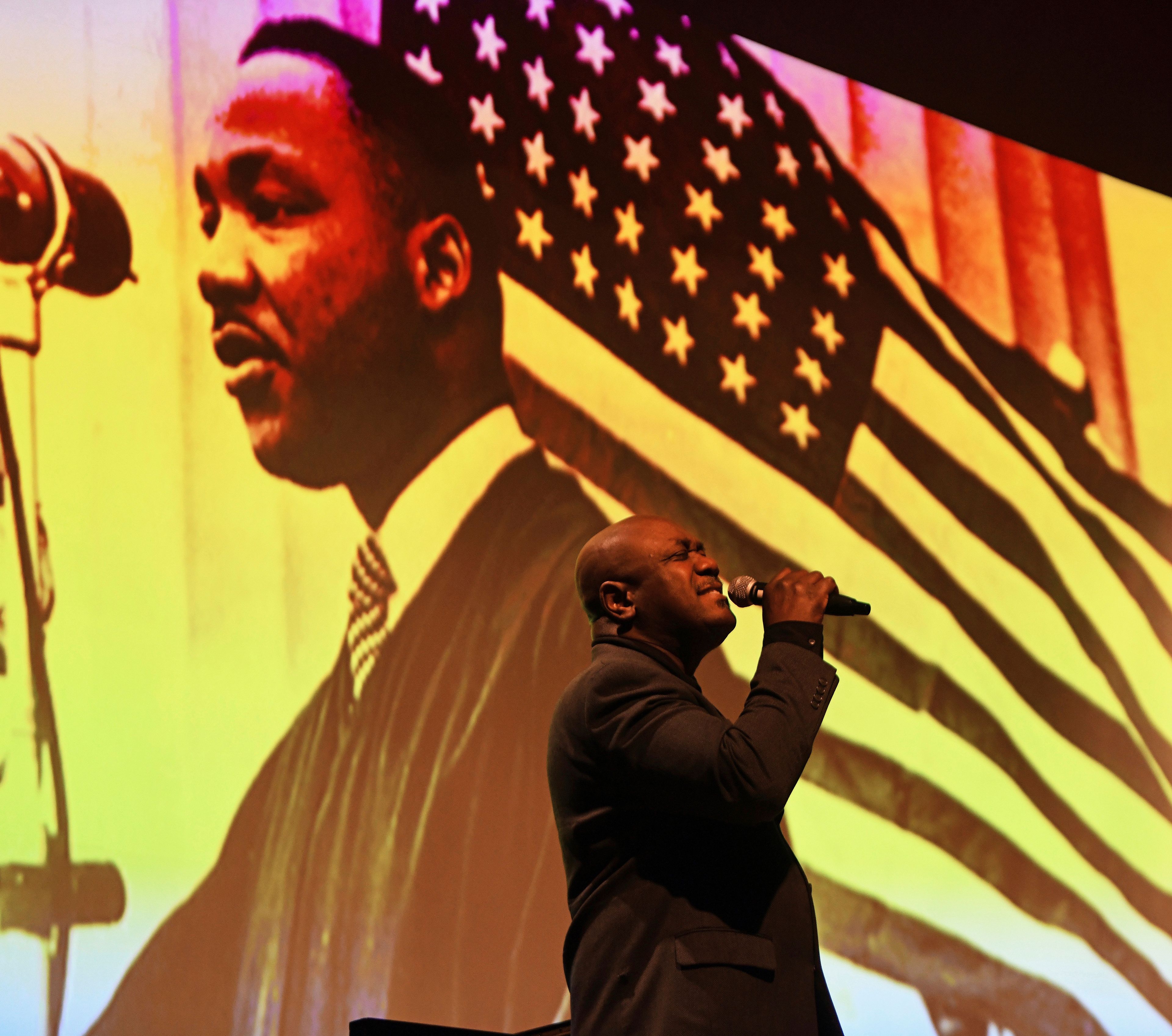 Joseph Patterson of Key Arts Production in Philadelphia, speaks during a multimedia event honoring the late Dr. Martin Luther King Jr., at a convocation ceremony at St. Francis University in Loretto, Pa., Monday, Jan. 16, 2023. (John Rucosky/The Tribune-Democrat via AP)