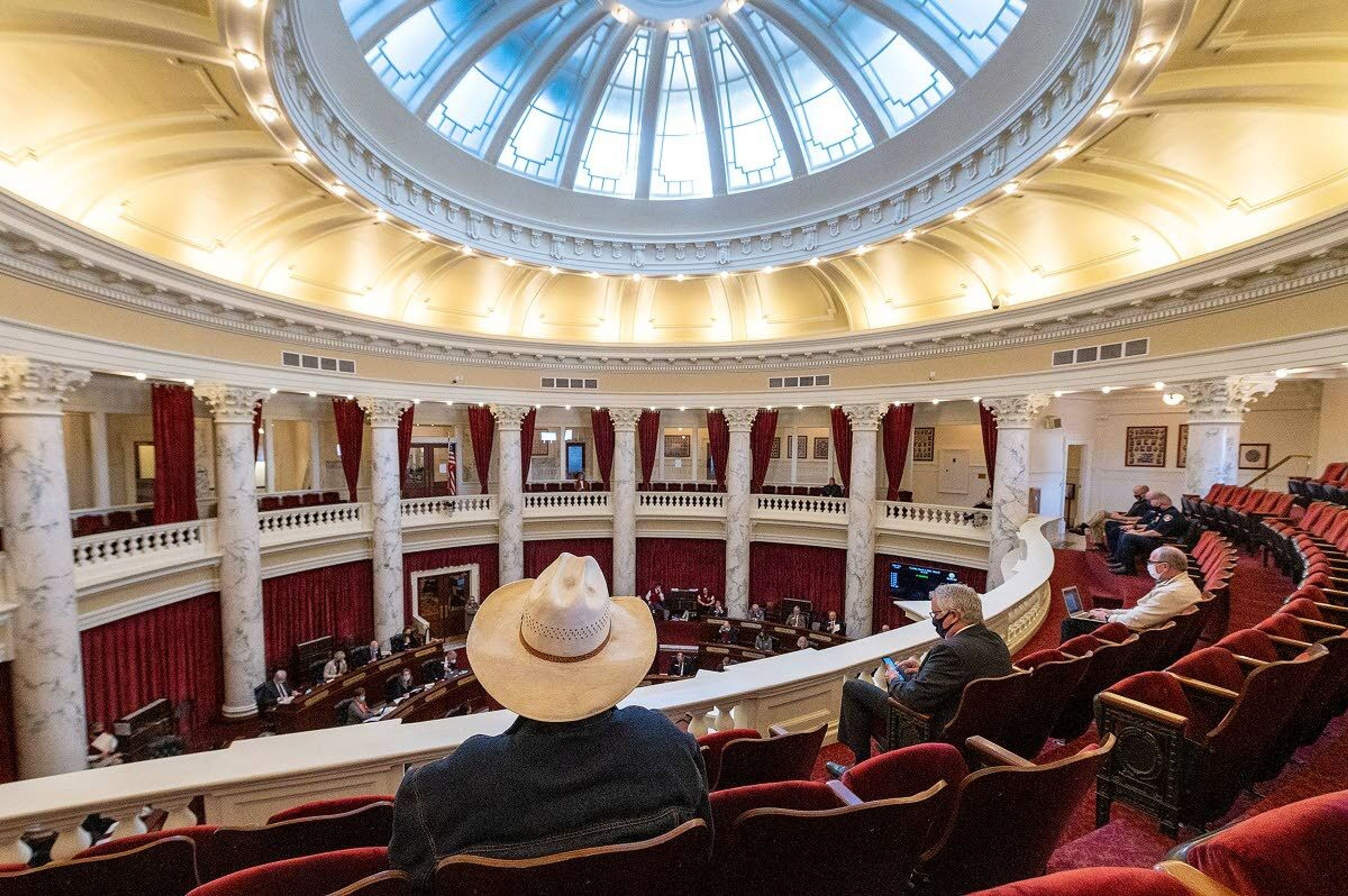 Visitors watch from the balcony as the Idaho State Senate holds a morning session earlier this month at the Idaho Capitol in Boise. The central part of the building — including the dome — was finished in 1912, while the two wings, which are home to the House and Senate chambers, were finished in 1919 and 1920, respectively.