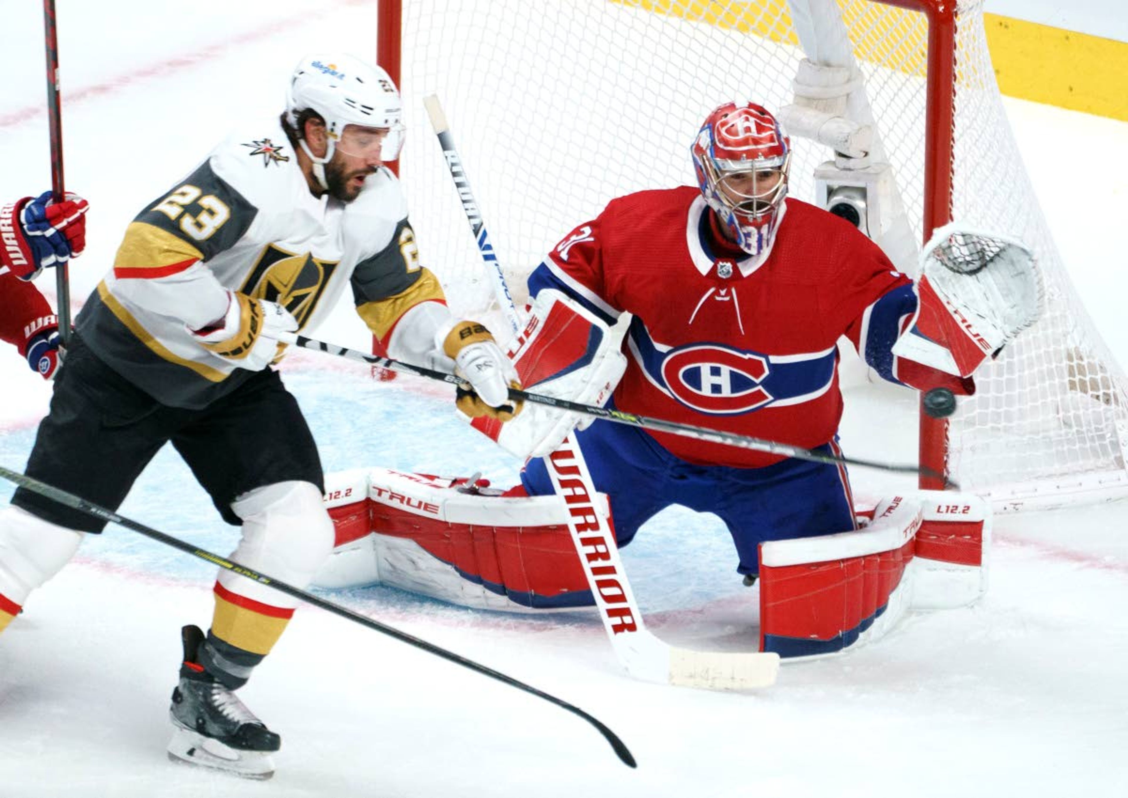 Vegas Golden Knights' Alec Martinez (23) tries to deflect a shot past Montreal Canadiens goaltender Carey Price during the second period in Game 6 of an NHL hockey Stanley Cup semifinal playoff series Thursday, June 24, 2021 in Montreal. (Paul Chiasson/The Canadian Press via AP)