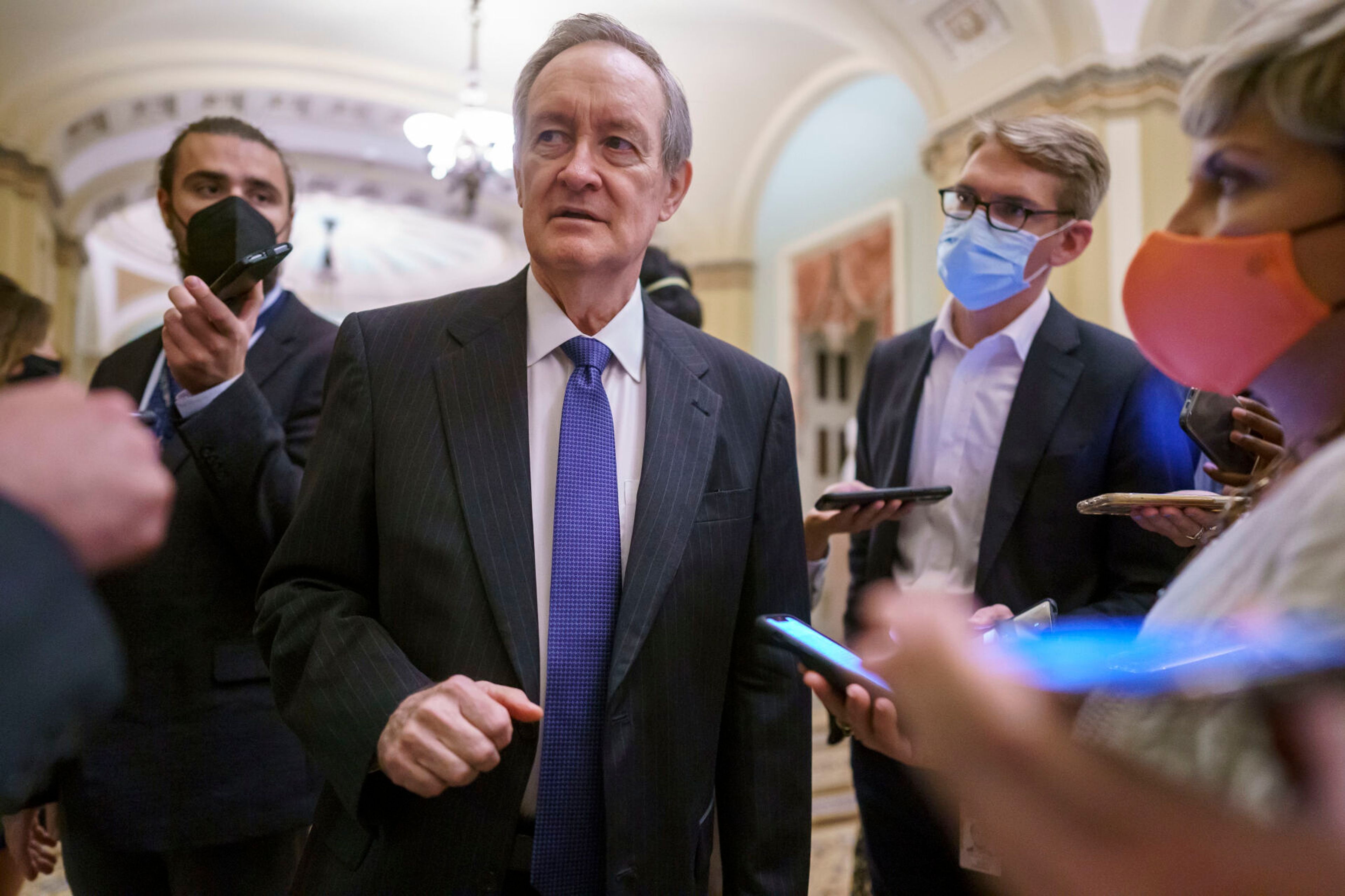 Sen. Mike Crapo, R-Idaho, is met by reporters outside the chamber after he and other GOP members met in closed-door meeting with Senate Minority Leader Mitch McConnell, R-Ky., at the Capitol in Washington, Wednesday, Oct. 6, 2021. McConnell has given Democrats a new offer to extend the federal debt ceiling through an emergency short-term extension. (AP Photo/J. Scott Applewhite)