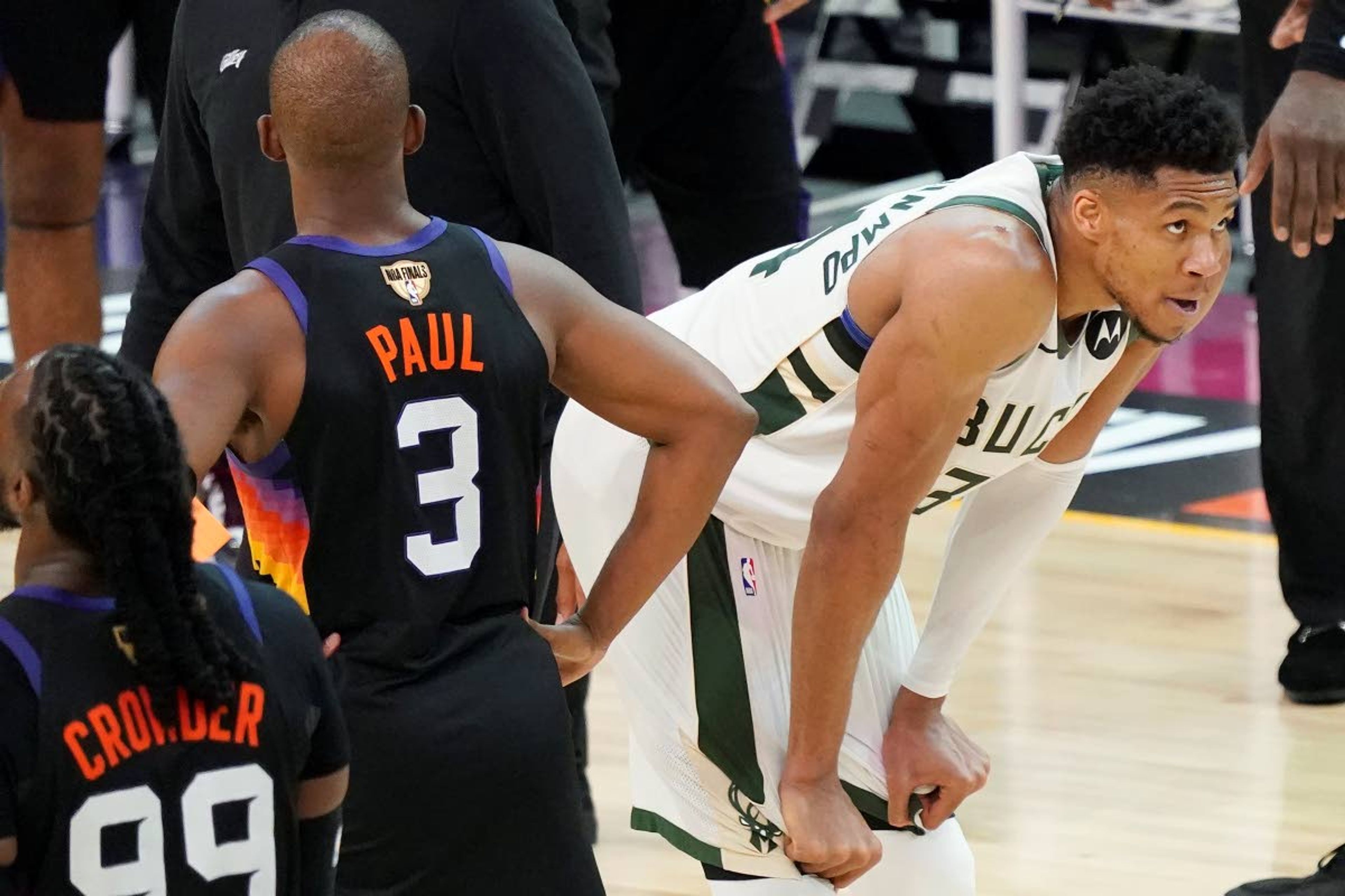 Phoenix Suns guard Chris Paul (3) walks past Milwaukee Bucks forward Giannis Antetokounmpo during the second half of Game 2 of basketball's NBA Finals, Thursday, July 8, 2021, in Phoenix. (AP Photo/Matt York)