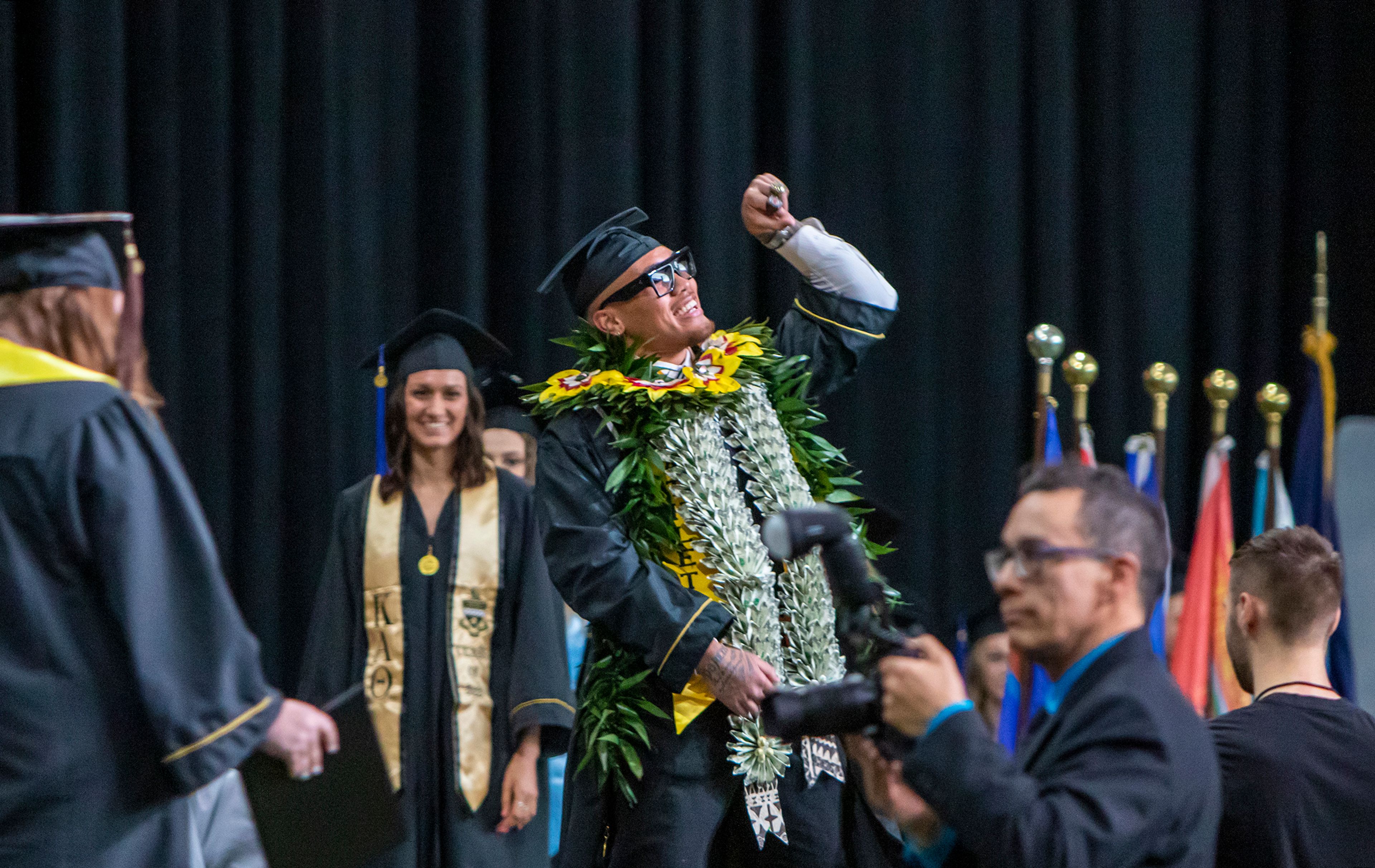 A graduate walks across the stage with style Saturday morning during the University of Idaho's 2022 Spring Commencement Ceremony at the Kibbie Dome in Moscow.