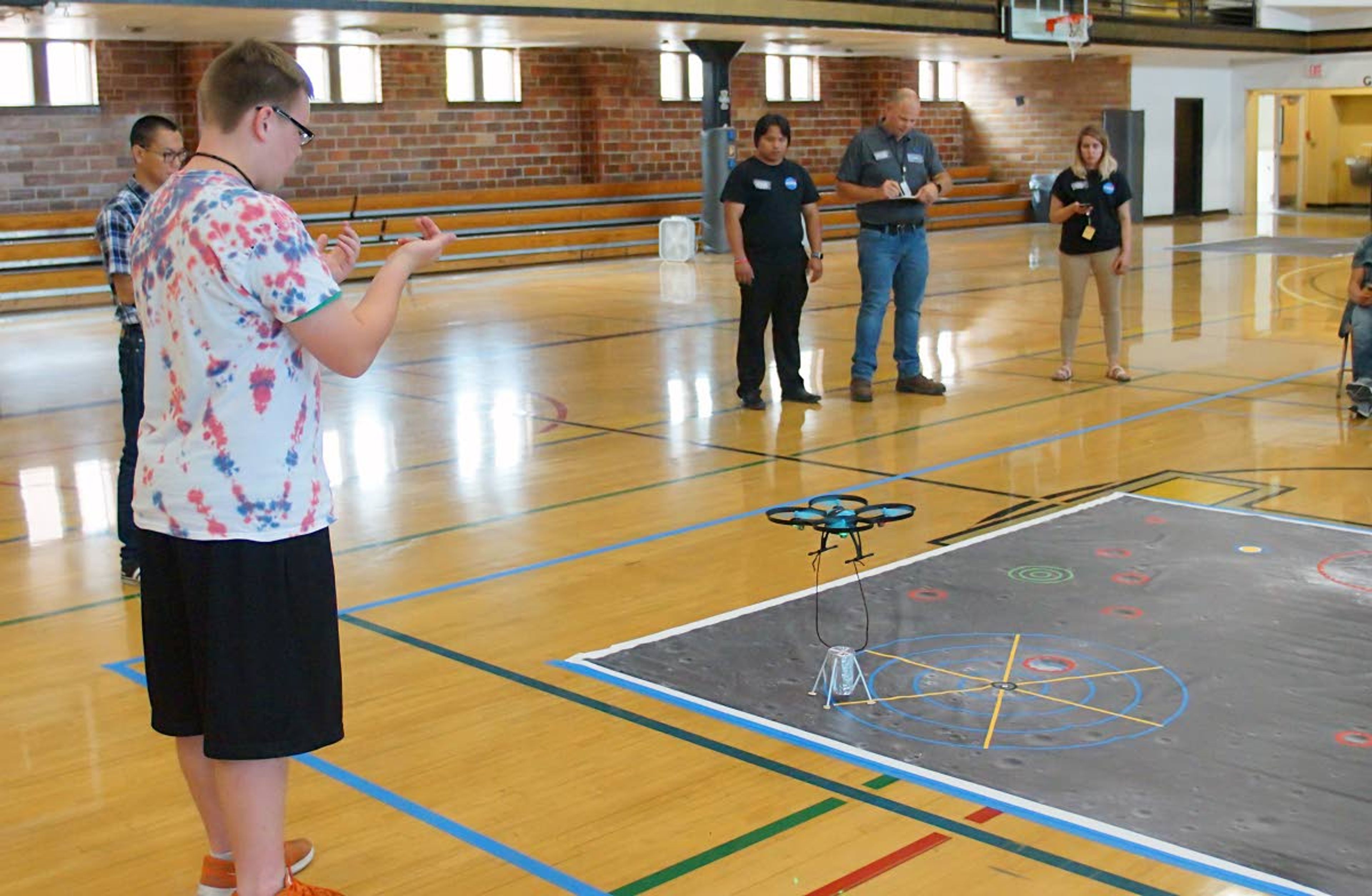 Clarkston’s Christian Charlton calls out and signals directions for a drone to pick up the team’s lunar lander during the NASA ANGLeS Challenge.