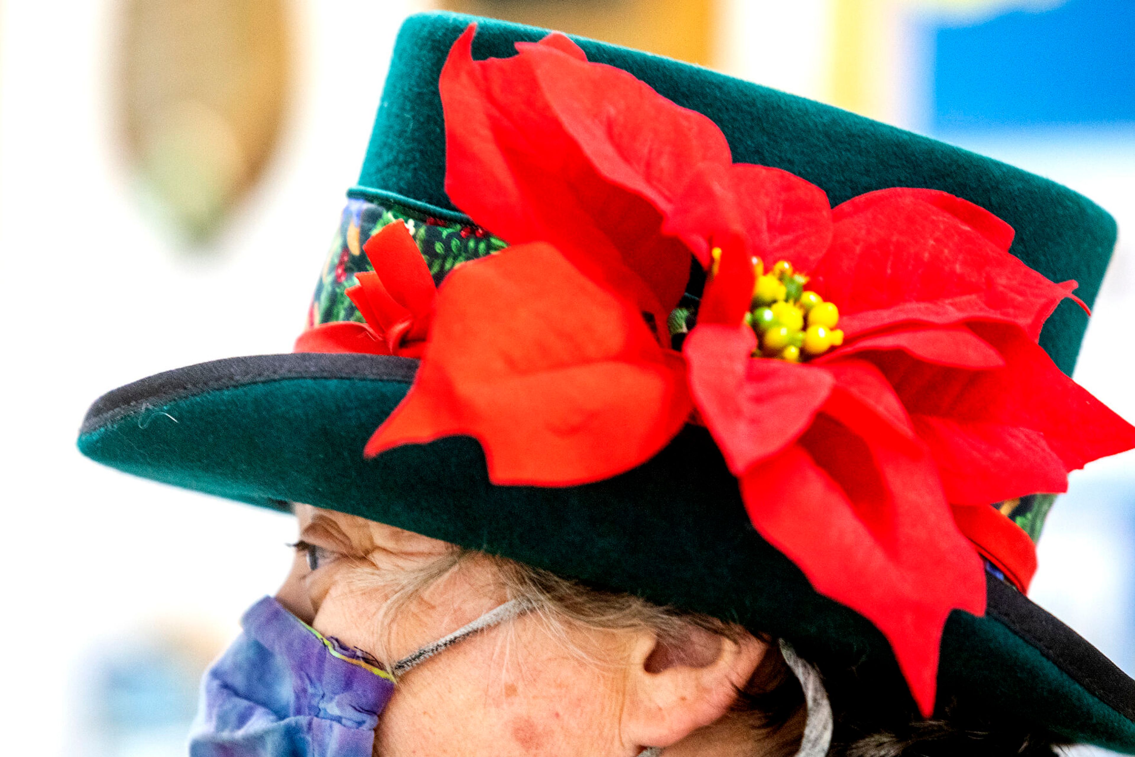 A flowery top hat sits on a women’s head as she discusses the Alternative Giving Market in Moscow on Saturday.