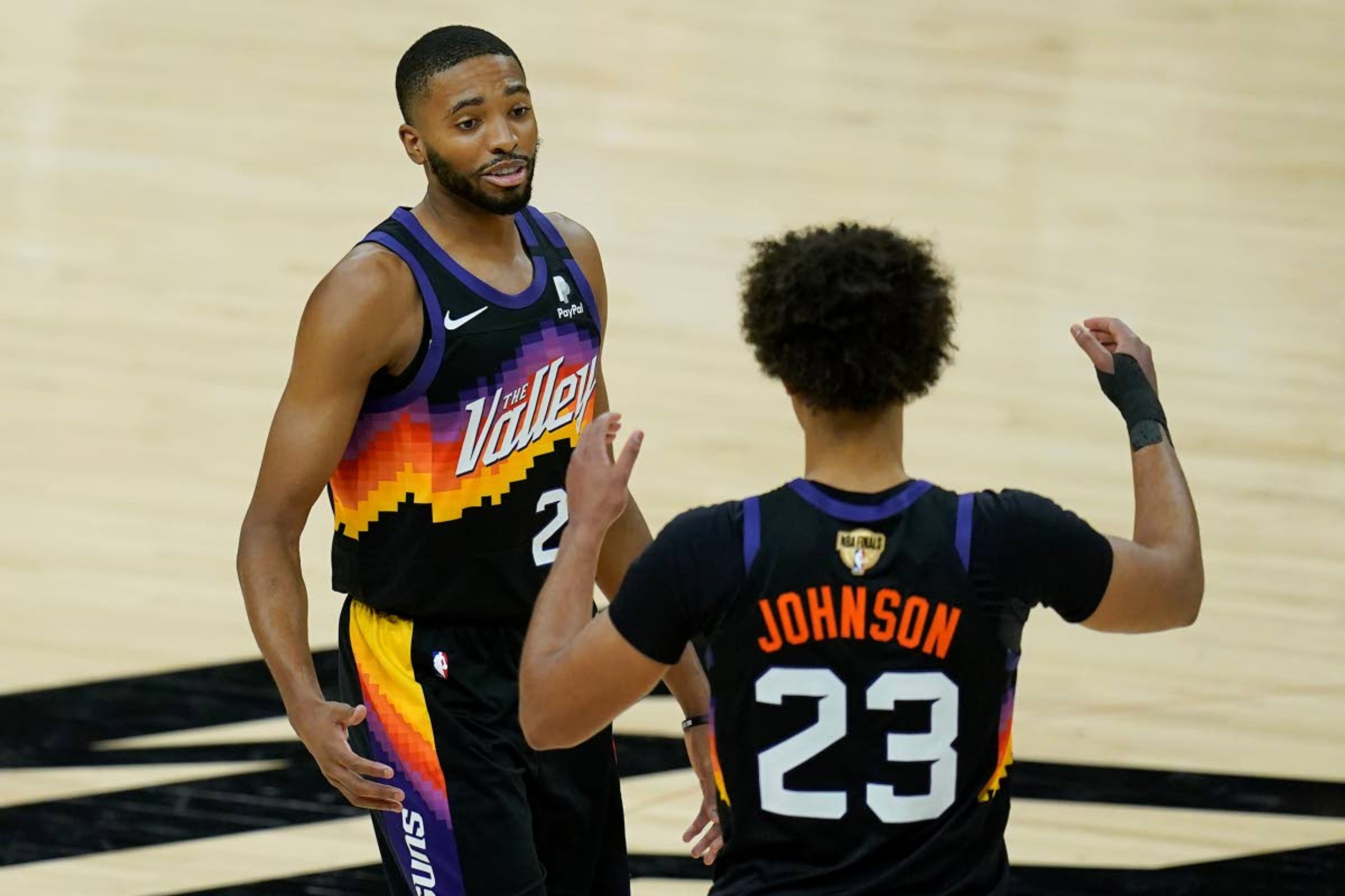 Phoenix Suns forward Mikal Bridges, left, celebrates with forward Cameron Johnson (23) during the second half of Game 2 of basketball's NBA Finals against the Milwaukee Bucks, Thursday, July 8, 2021, in Phoenix. (AP Photo/Ross D. Franklin)