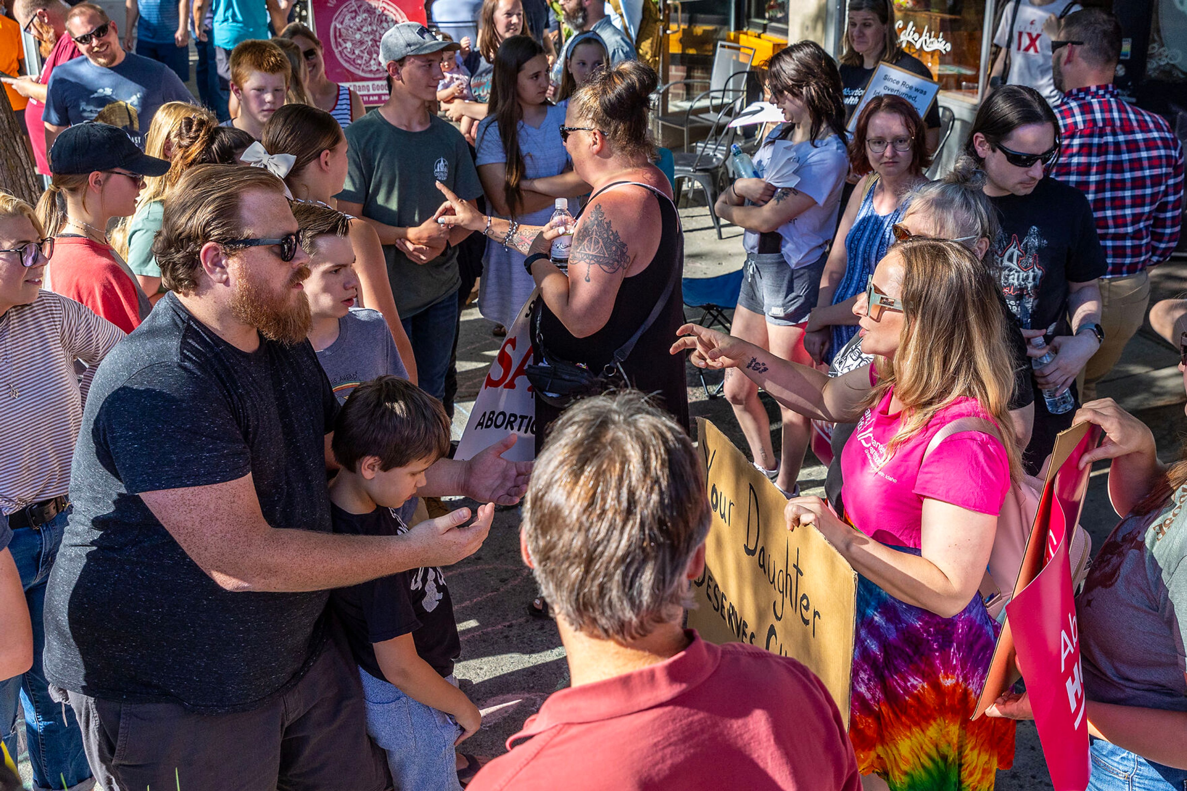 People argue during a block party celebrating the anniversary of the overturning of Roe v. Wade on Main Street Monday in Moscow.