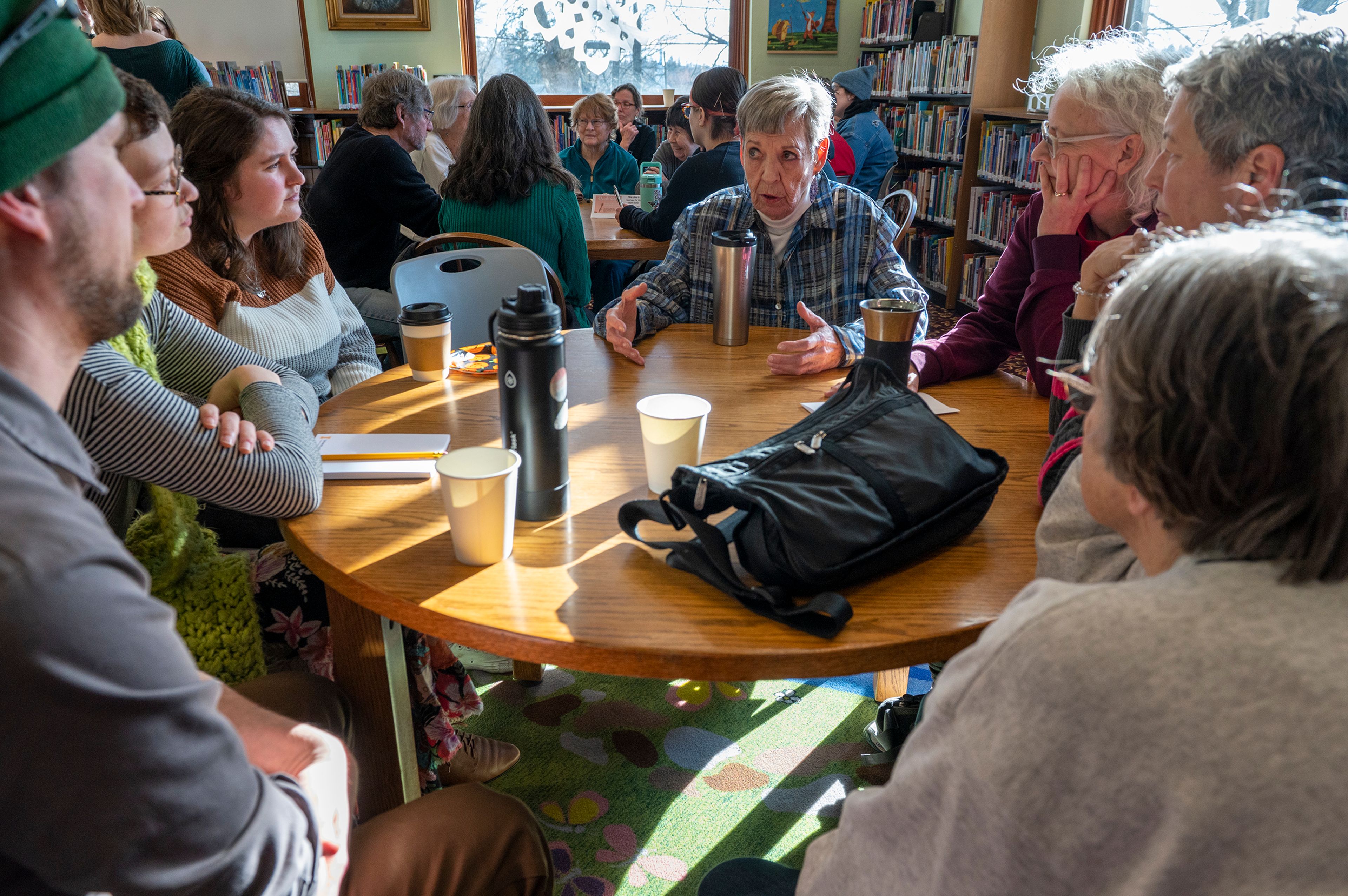 Karen Barron, center, speaks in a small group during a Death Café at the Moscow Public Library on Tuesday.