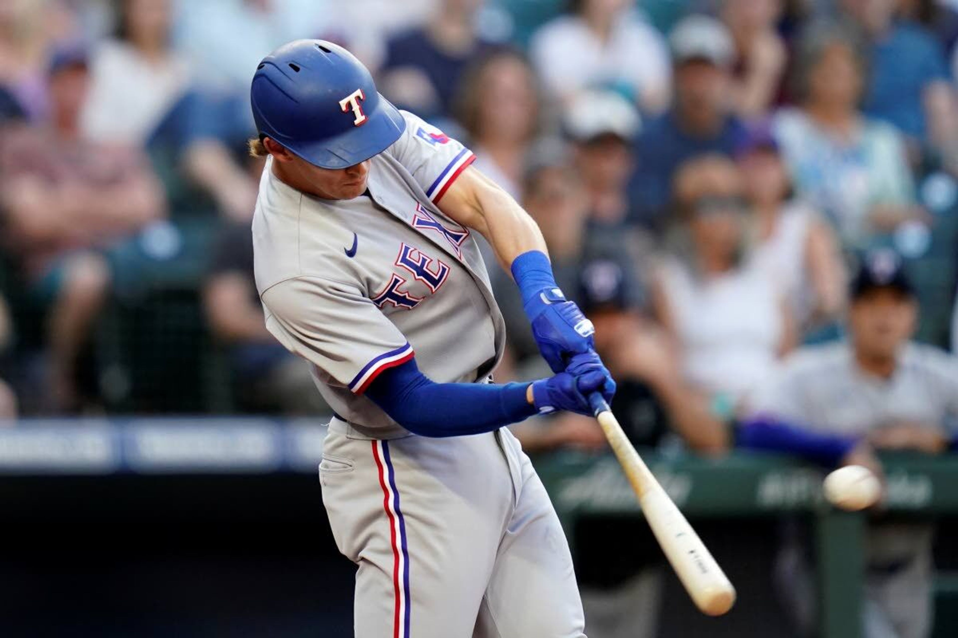 Texas Rangers' Eli White connects for a three-run home run against the Seattle Mariners during the third inning of a baseball game Saturday, July 3, 2021, in Seattle. (AP Photo/Elaine Thompson)