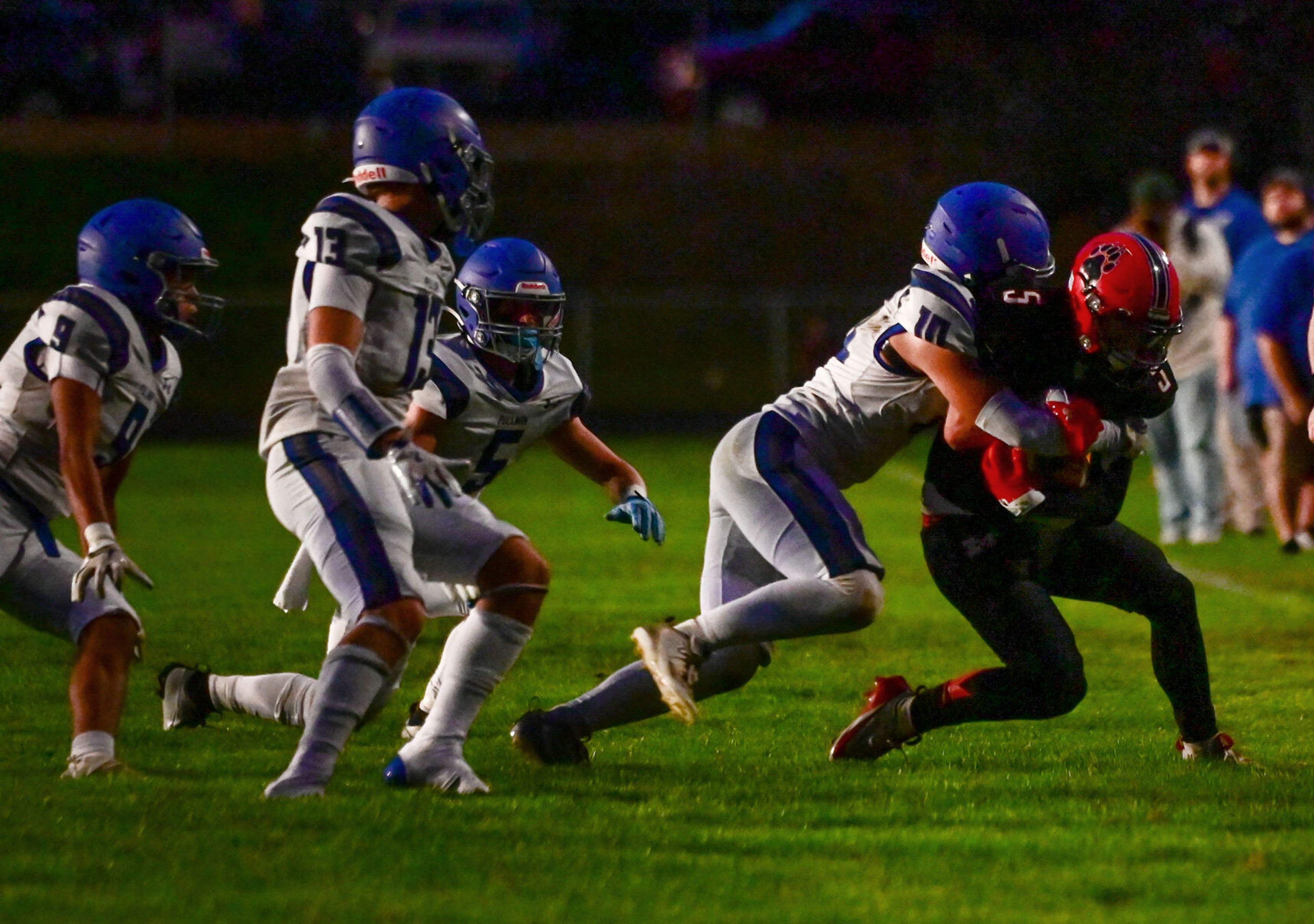 Pullman defensive back Caleb Ratliff tackles Moscow wide receiver Connor Isakson Friday in Moscow.