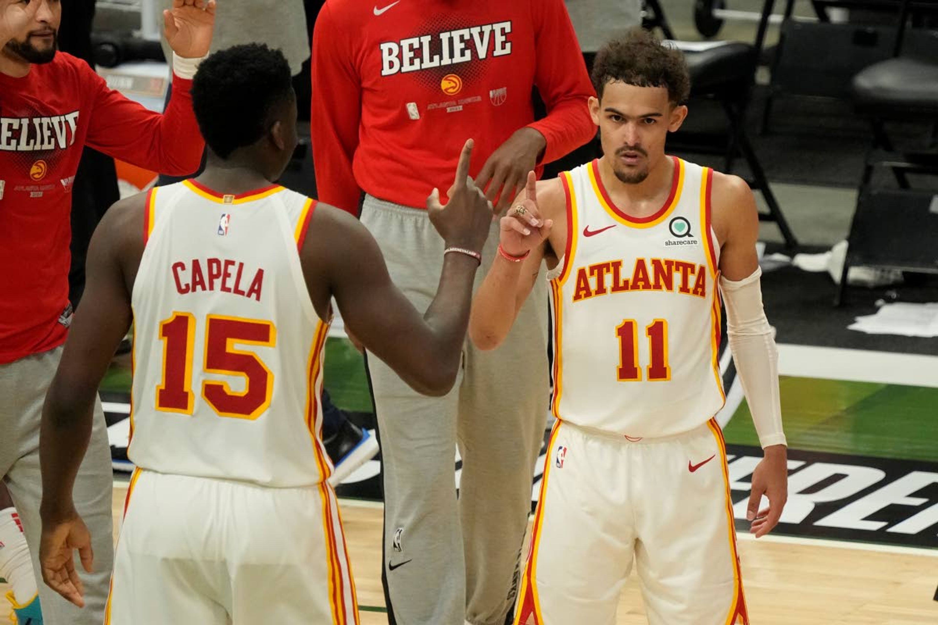 Atlanta Hawks' Trae Young and Clint Capela celebrate after Game 1 of the NBA Eastern Conference basketball finals game against the Milwaukee Bucks Wednesday, June 23, 2021, in Milwaukee. The Hawks won 116-113 to take a 1-0 lead in the series. (AP Photo/Morry Gash)