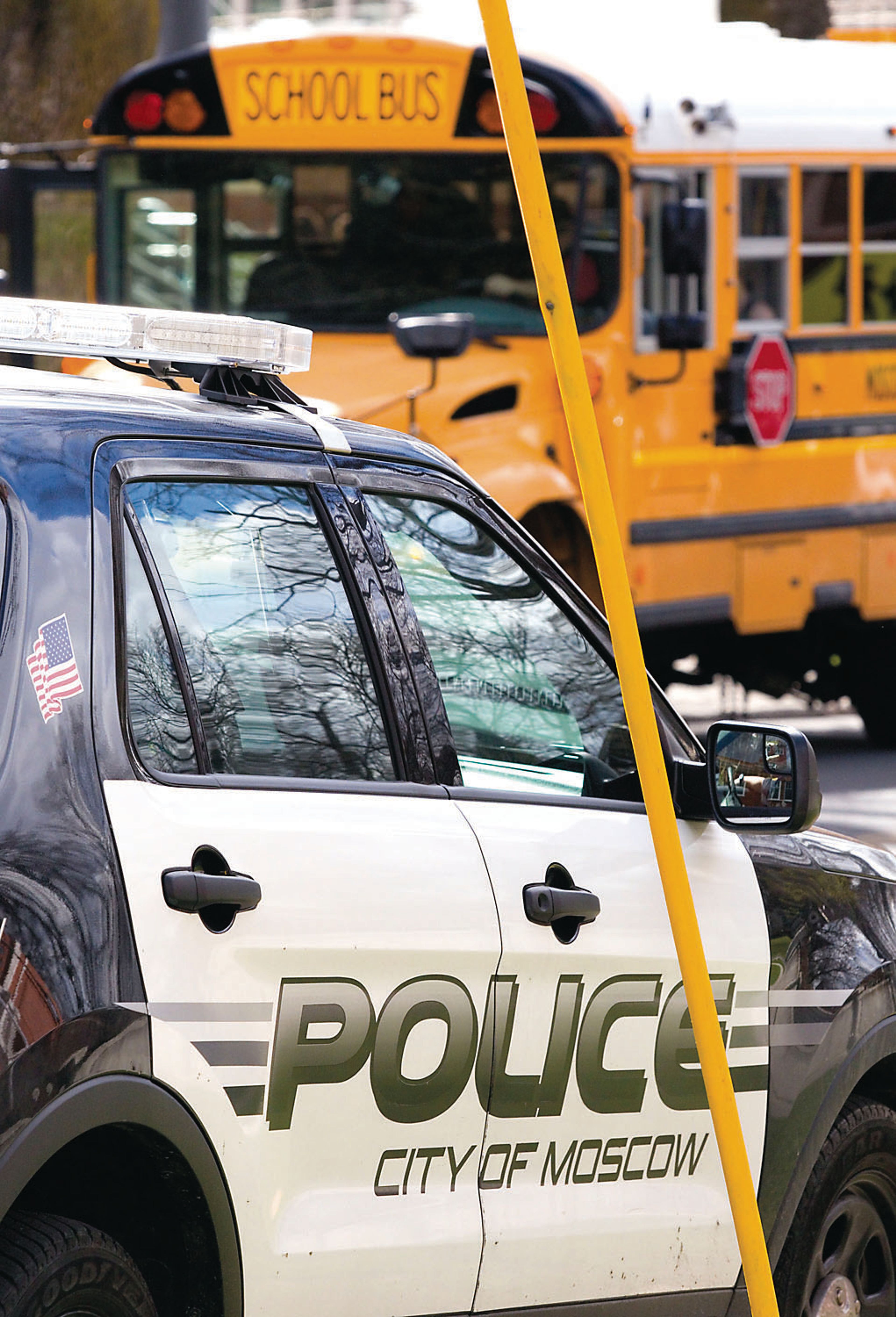 A Moscow police officer parks outside Moscow High School on Monday after classes.