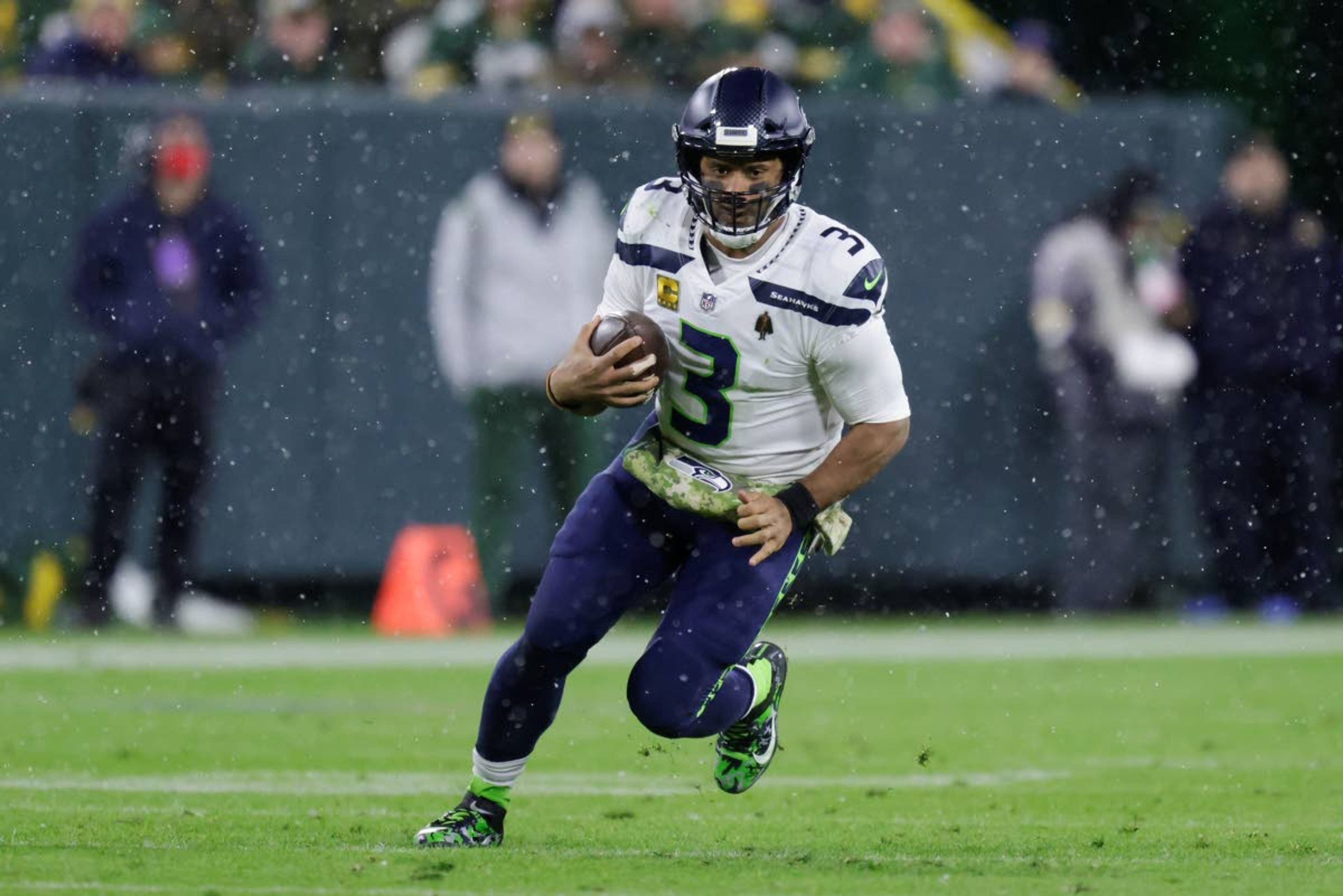 Seattle Seahawks' Russell Wilson runs during the second half of an NFL football game against the Green Bay Packers Sunday, Nov. 14, 2021, in Green Bay, Wis. (AP Photo/Matt Ludtke)