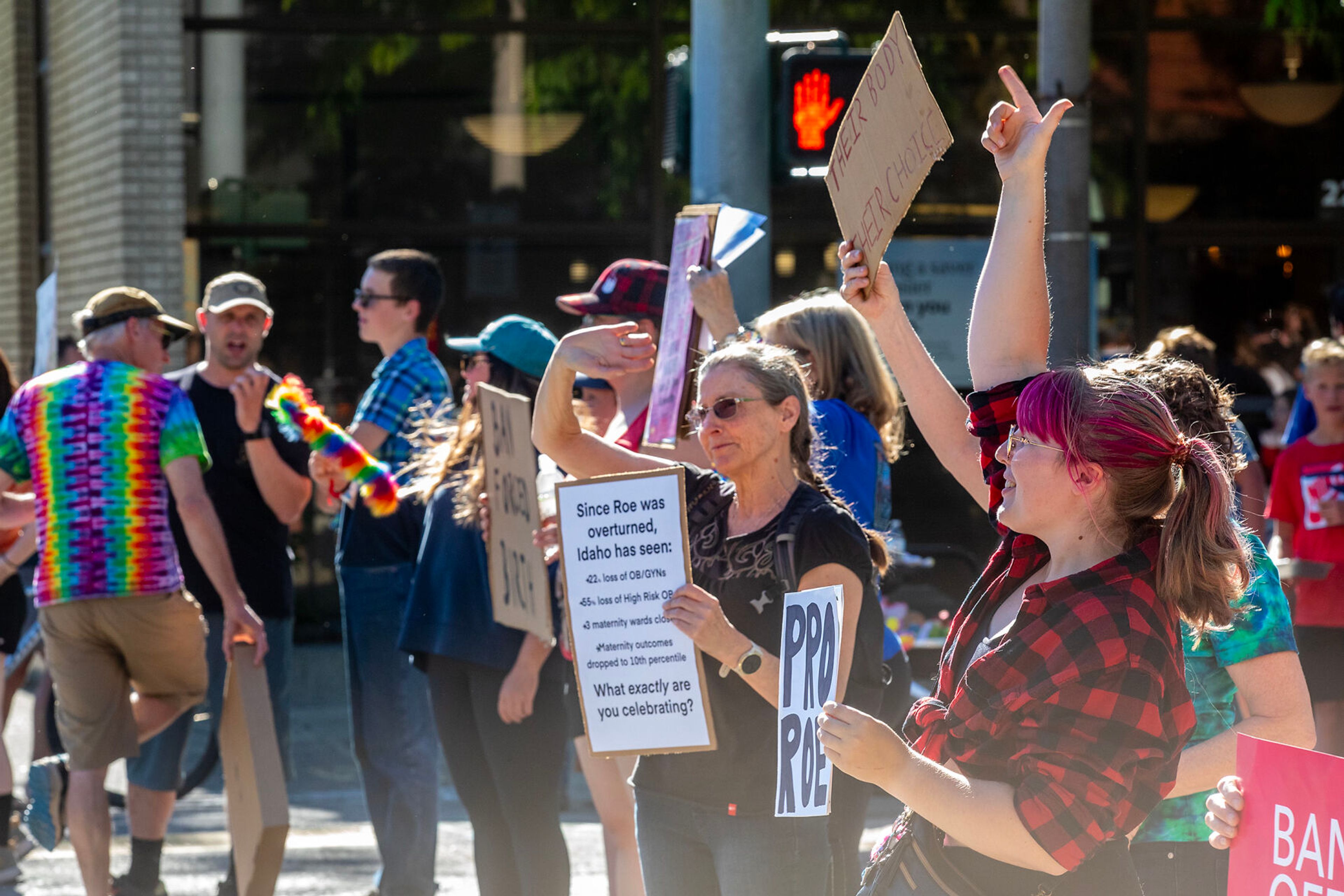 Counter protesters hold signs during a block party celebrating the anniversary of the overturning of Roe v. Wade on Main Street Monday in Moscow.