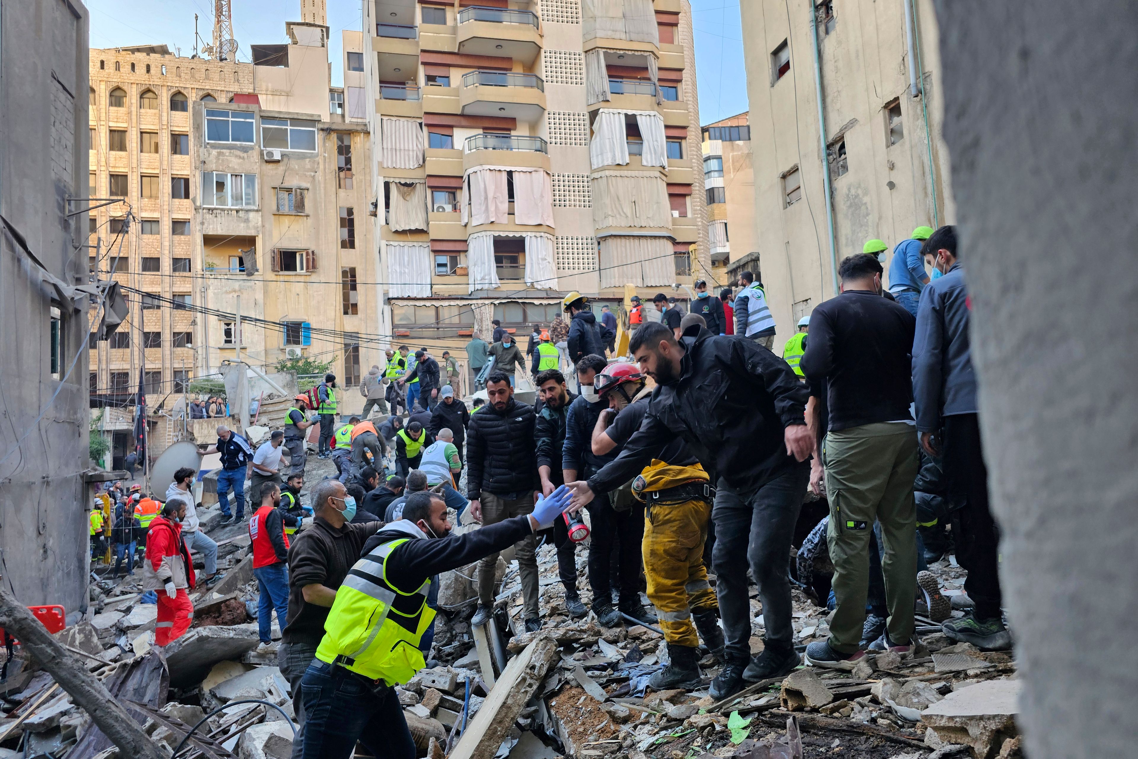 Rescuers search for victims at the site of an Israeli airstrike that targeted a building in Beirut, Lebanon, Tuesday, Nov. 26, 2024. (AP Photo/Hassan Ammar)