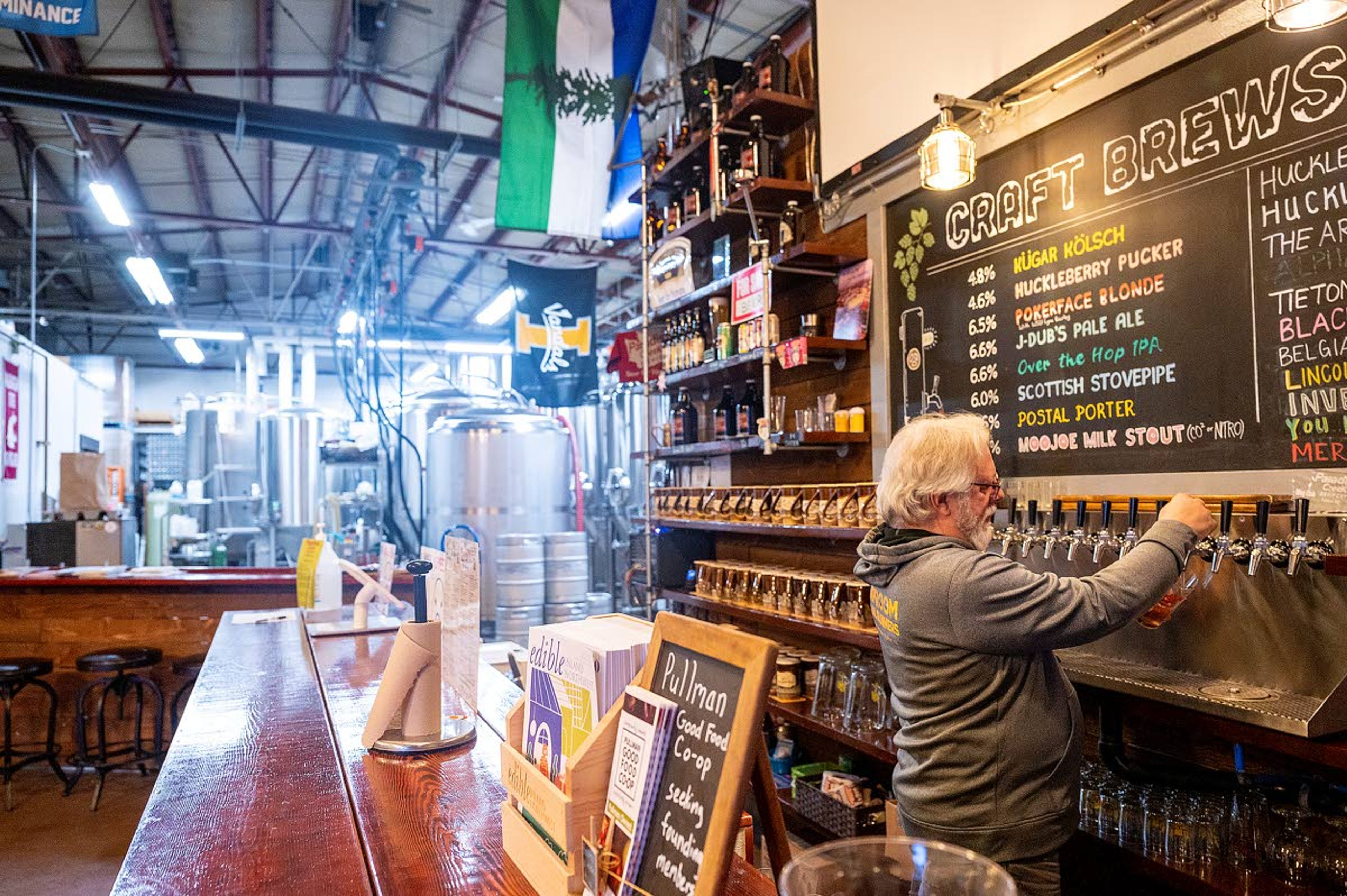 Tom Handy, owner of Paradise Creek Brewery, pours a beer Friday from the multiple taps available at the Trailside Taproom in Pullman.