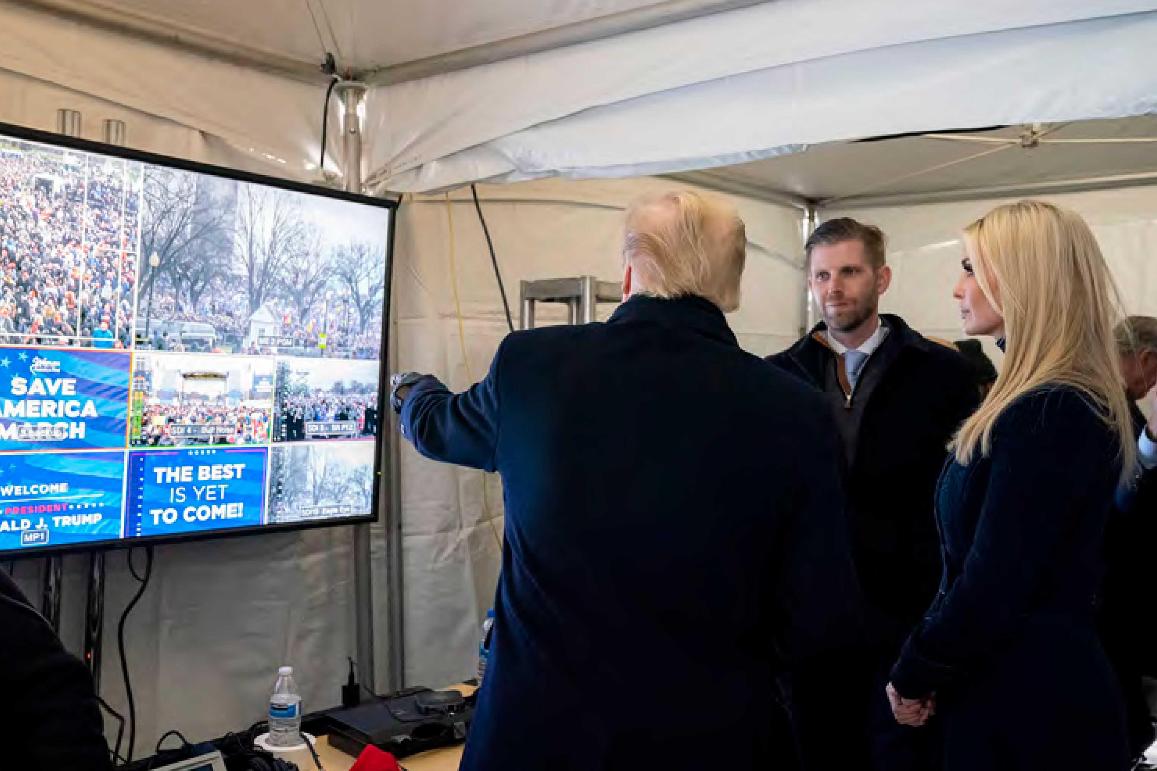 In this image released in the final report by the House select committee investigating the Jan. 6 attack on the U.S. Capitol, on Thursday, Dec. 22, 2022, President Donald Trump looks at video monitors showing the crowd gathered on the Ellipse on the morning of Jan. 6, 2021, before he spoke. At rights is Ivanka Trump and second from right is Eric Trump. (House Select Committee via AP)