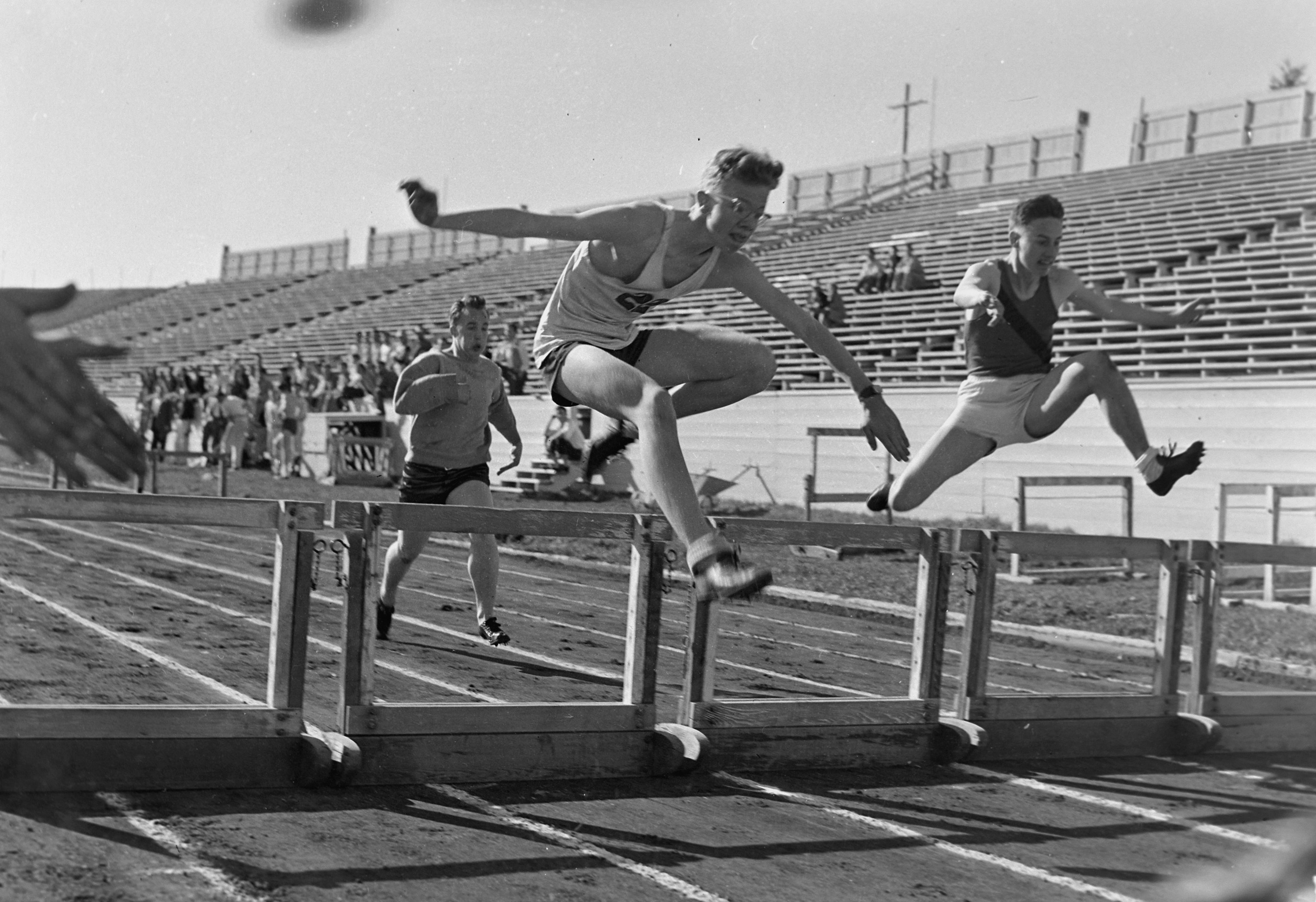 Hurdlers are photographed at a University of Idaho track meet circa 1952-56.