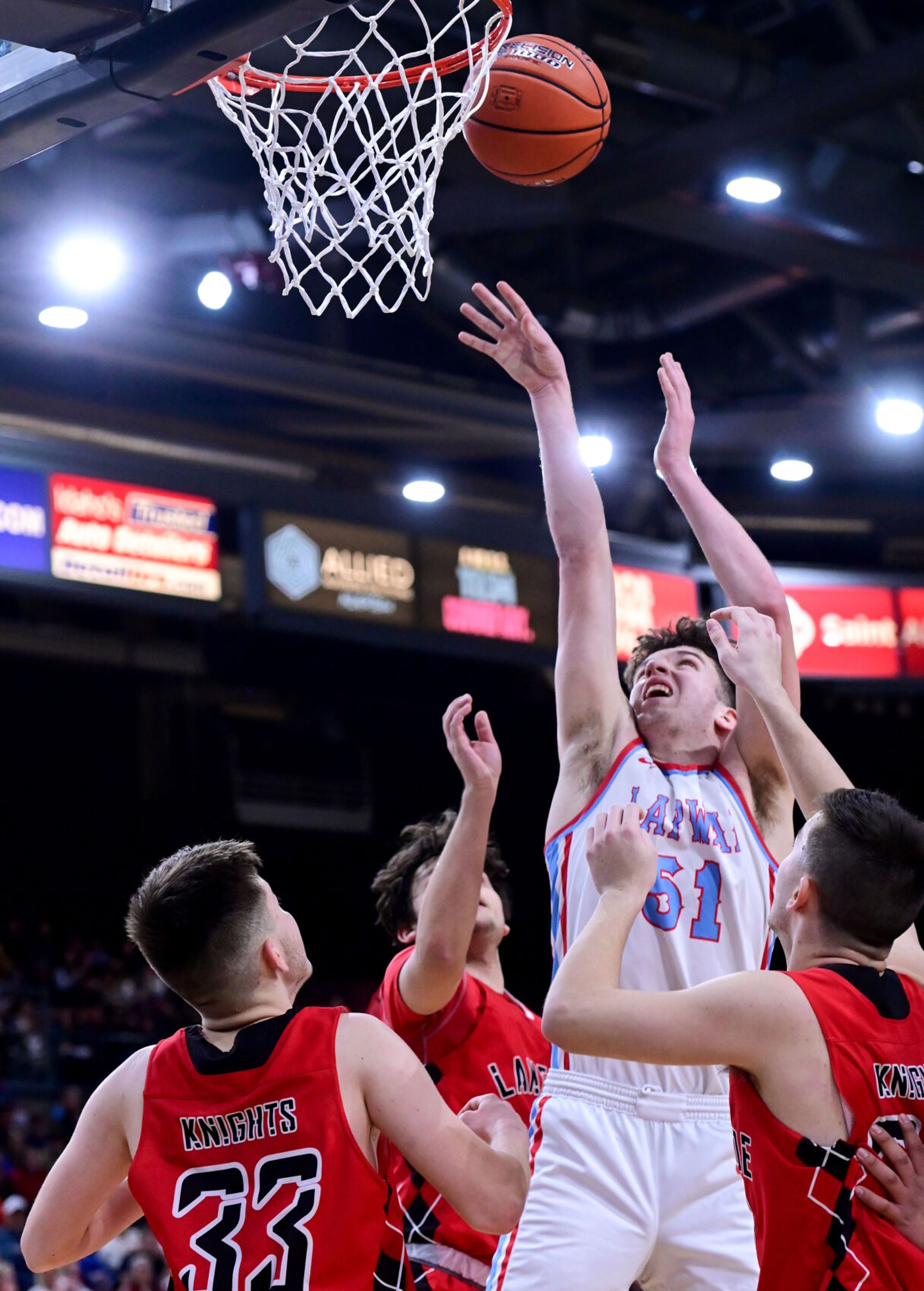 Lapwai point guard Kase Wynott makes a two-point shot with Lakeside defenders on all sides during the championship game at the Ford Idaho Center in Nampa on Saturday. The Wildcats came out on top, winning the state title with a 67-54 final.