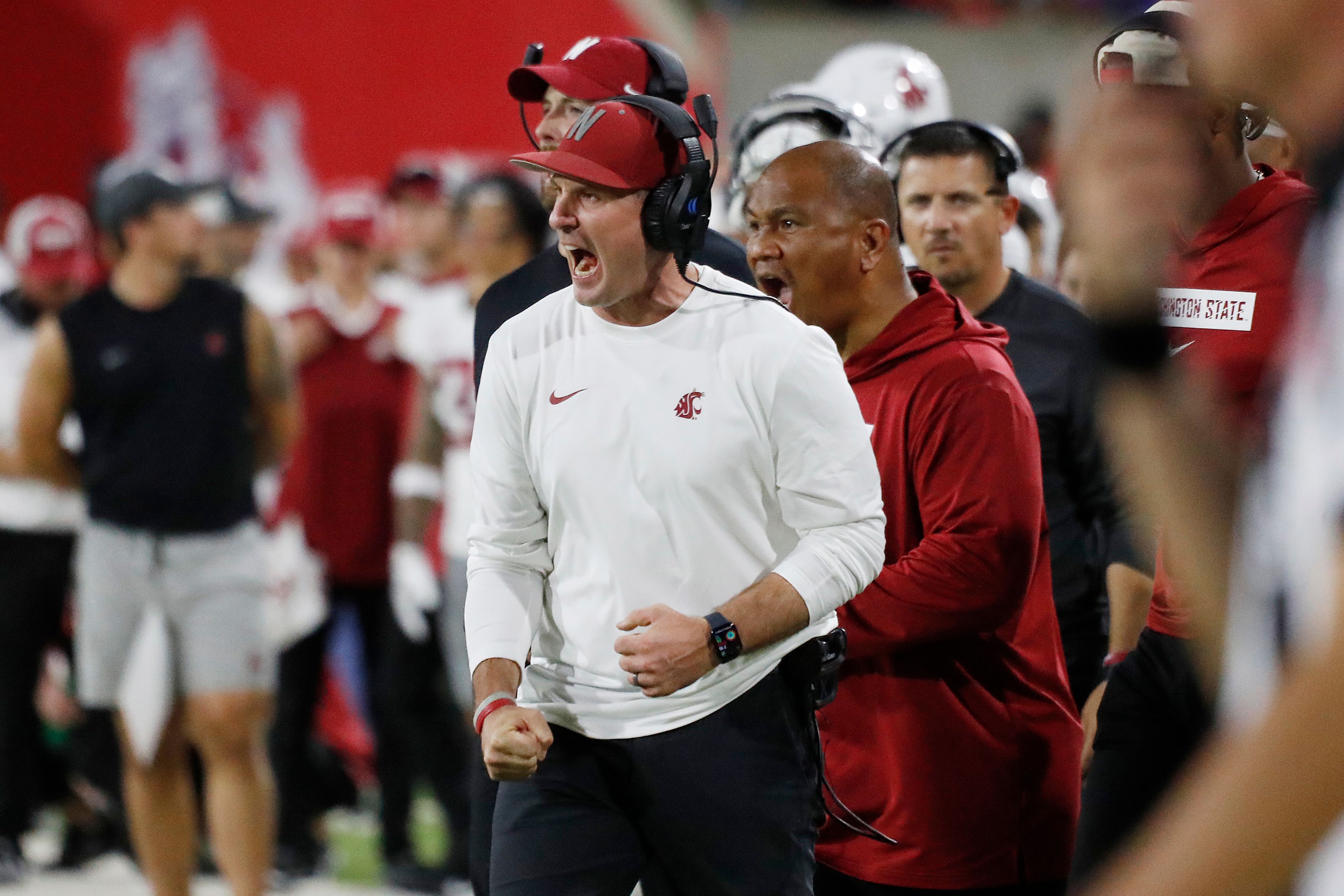 Washington State head coach Jake Dickert, center, fires up his team against Fresno State during the second half of an NCAA college football game in Fresno, Calif., Saturday, Oct. 12, 2024. (AP Photo/Gary Kazanjian)