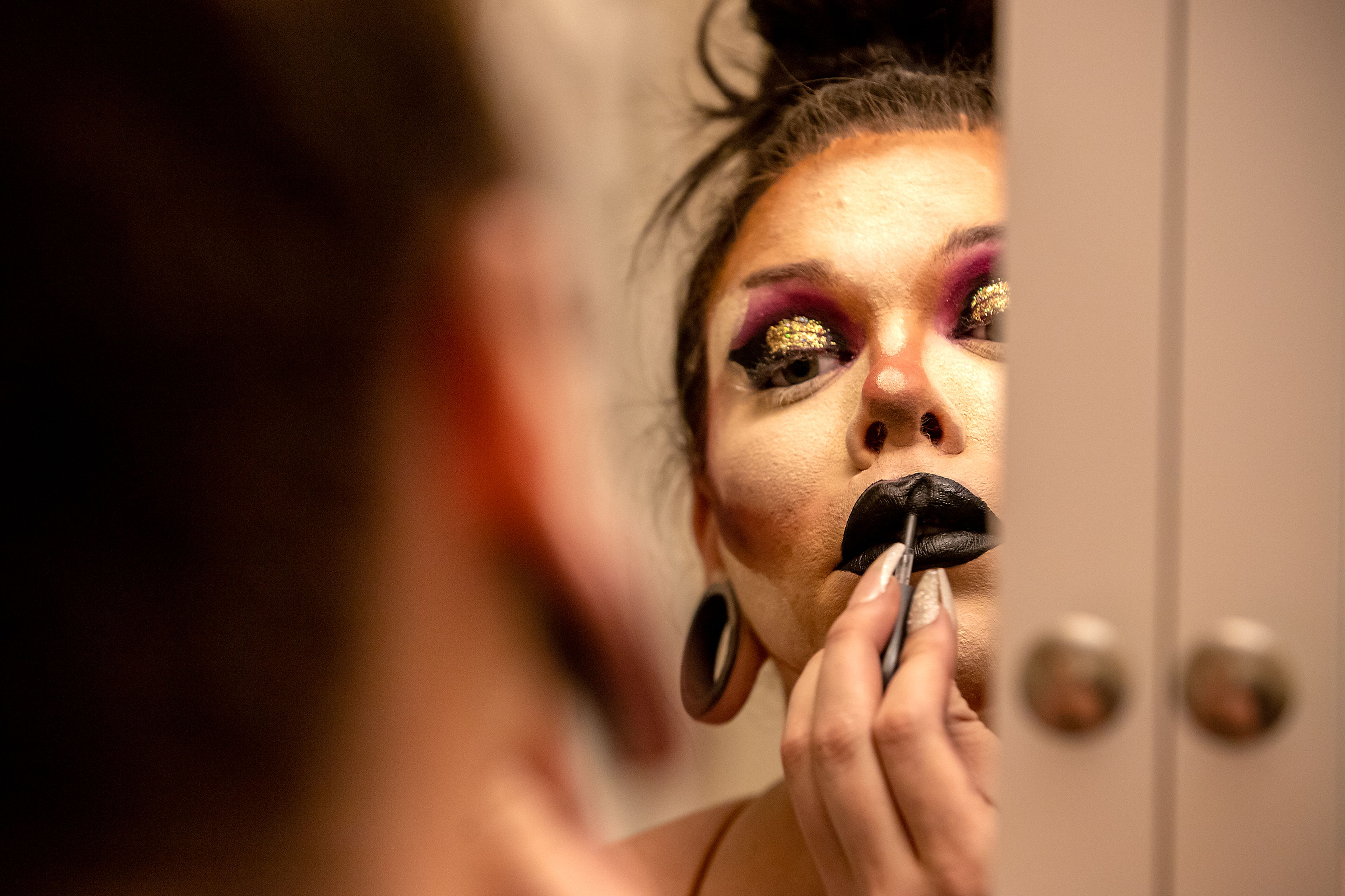 Wabaunsee applies some final touches to her makeup March 14 at her AirBnB rental. A dark and gothic theme runs through many of Wabaunsee’s elaborate drag outfits, which coincides with her hard rock musical taste.